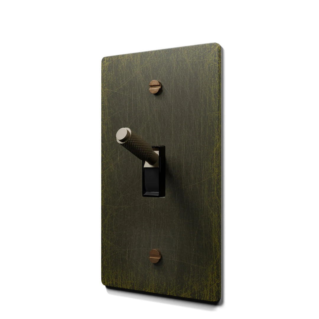 Bronze-colored light switch cover with a toggle switch on a white background