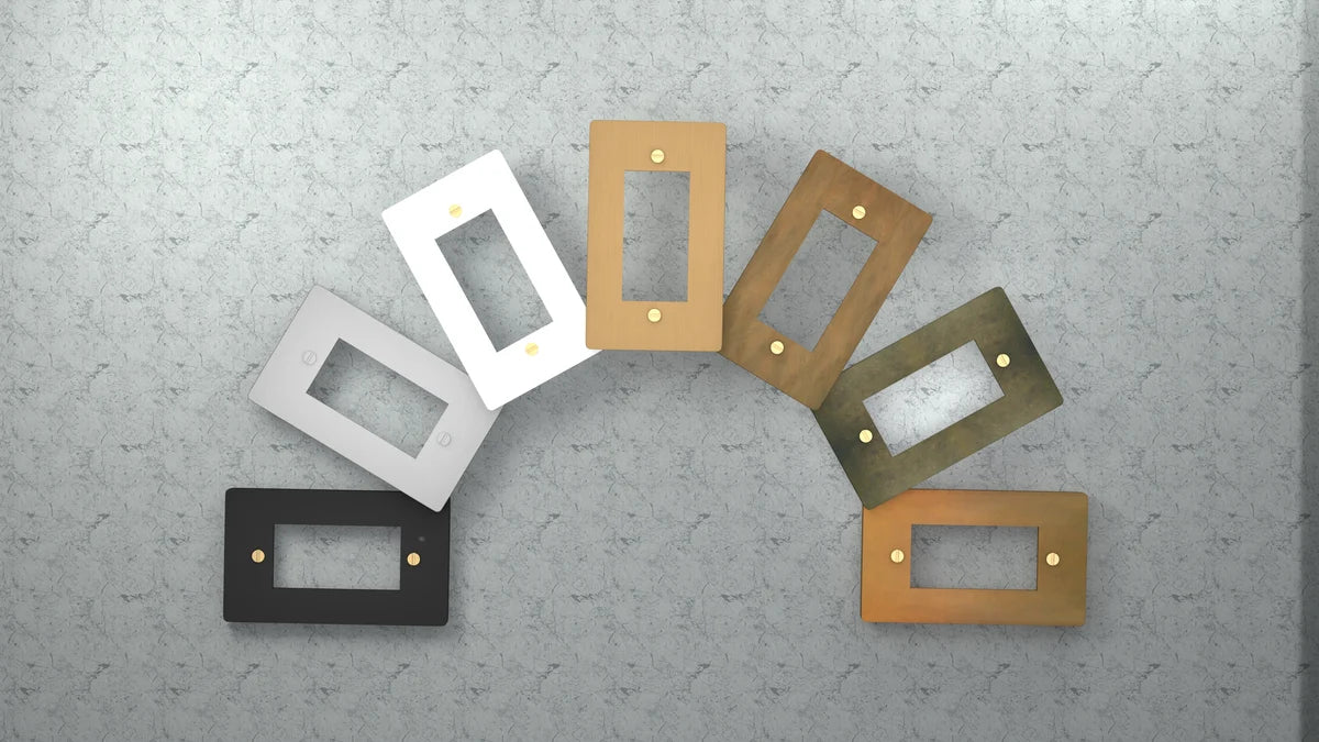 Set of rectangular light switch covers in various colors on a textured gray surface