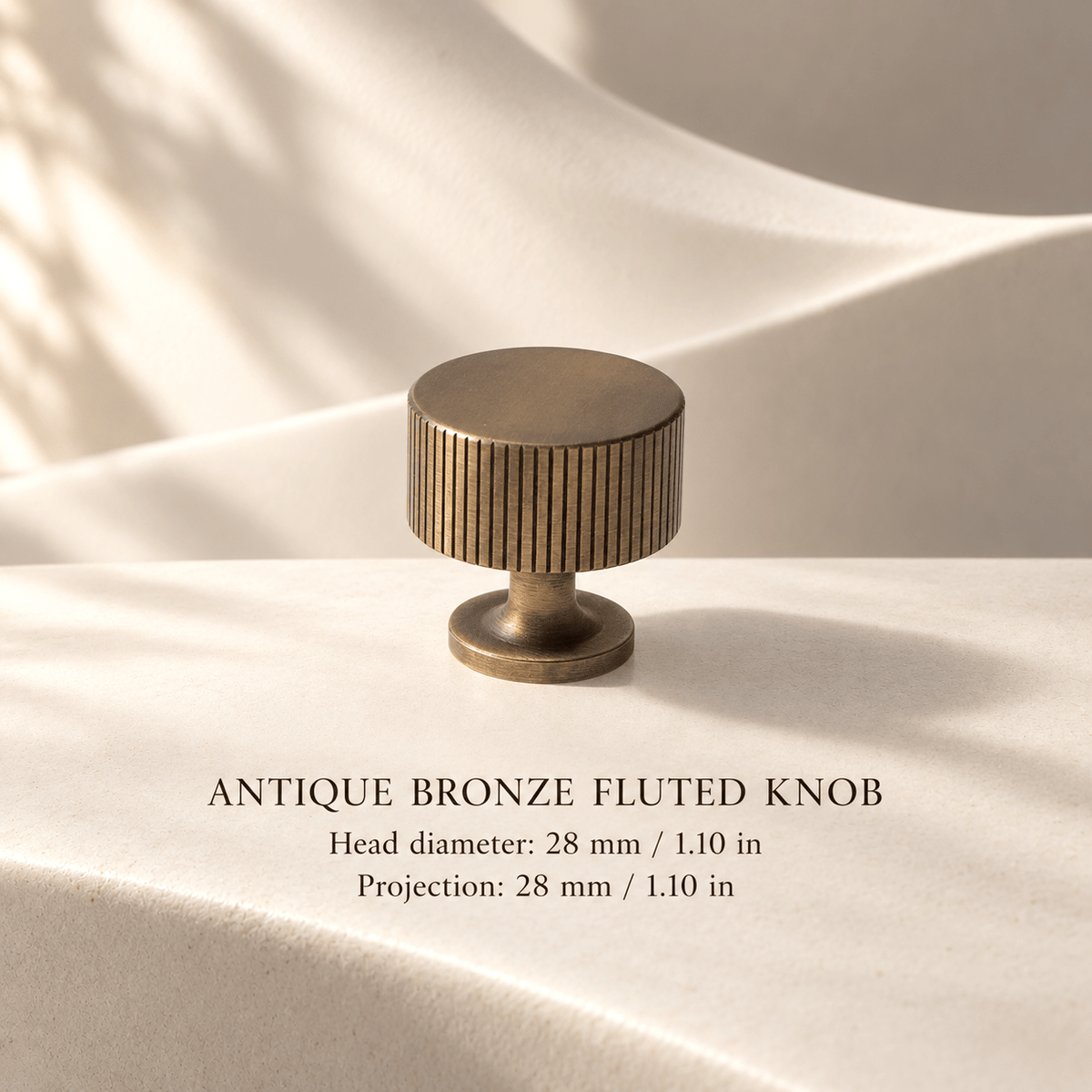Antique bronze fluted knob in ivory studio. Head diameter: 28 mm / 1.10 in; Projection: 28 mm / 1.10 in.