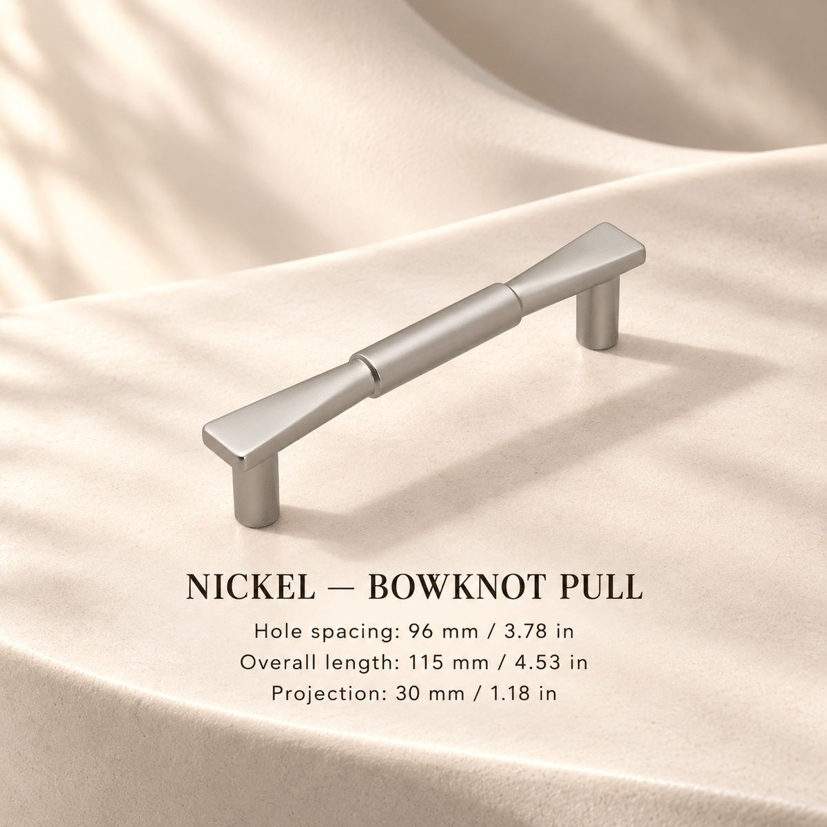 NICKEL bowknot cabinet pull in ivory studio. Hole spacing: 96 mm / 3.78 in; Overall length: 115 mm / 4.53 in; Projection: 30 mm / 1.18 in.