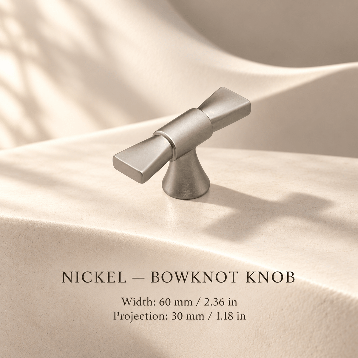 NICKEL bowknot T-knob in ivory studio. Width: 60 mm / 2.36 in; Projection: 30 mm / 1.18 in.