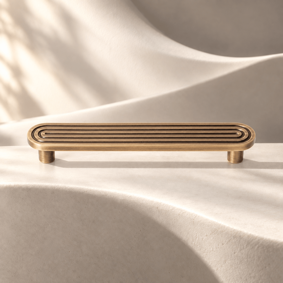 Bronze grooved cabinet pull, 128 mm hole spacing on ivory stone
