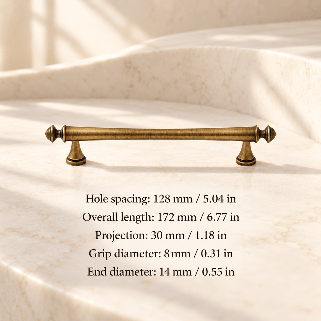 Antique bronze pointed finial 128 mm / 5.04 in CTC; Hole spacing: 128 mm / 5.04 in; Overall length: 172 mm / 6.77 in; Projection: 30 mm / 1.18 in; Grip diameter: 8 mm / 0.31 in; End diameter: 14 mm / 0.55 in on ivory stone studio background
