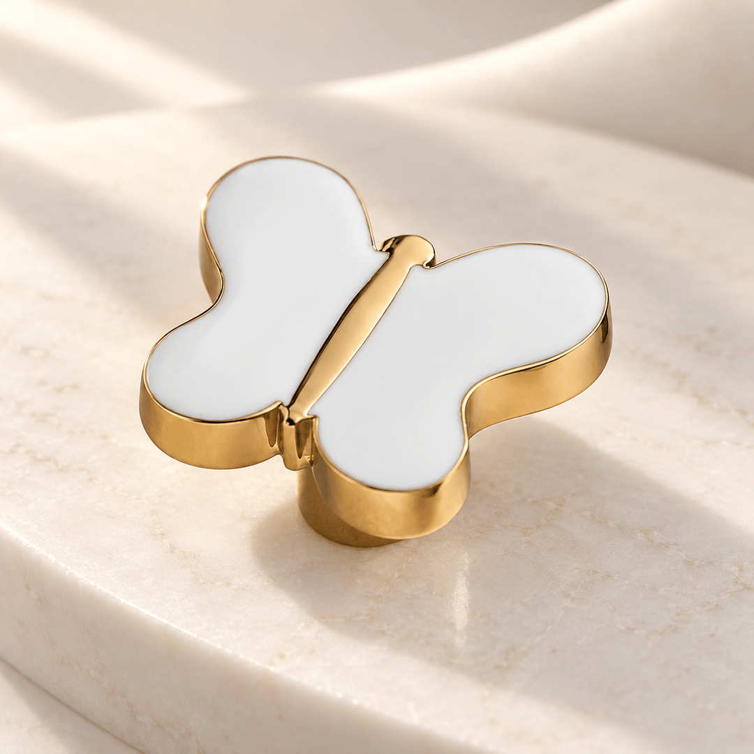 White butterfly cabinet knob in gold finish on ivory stone