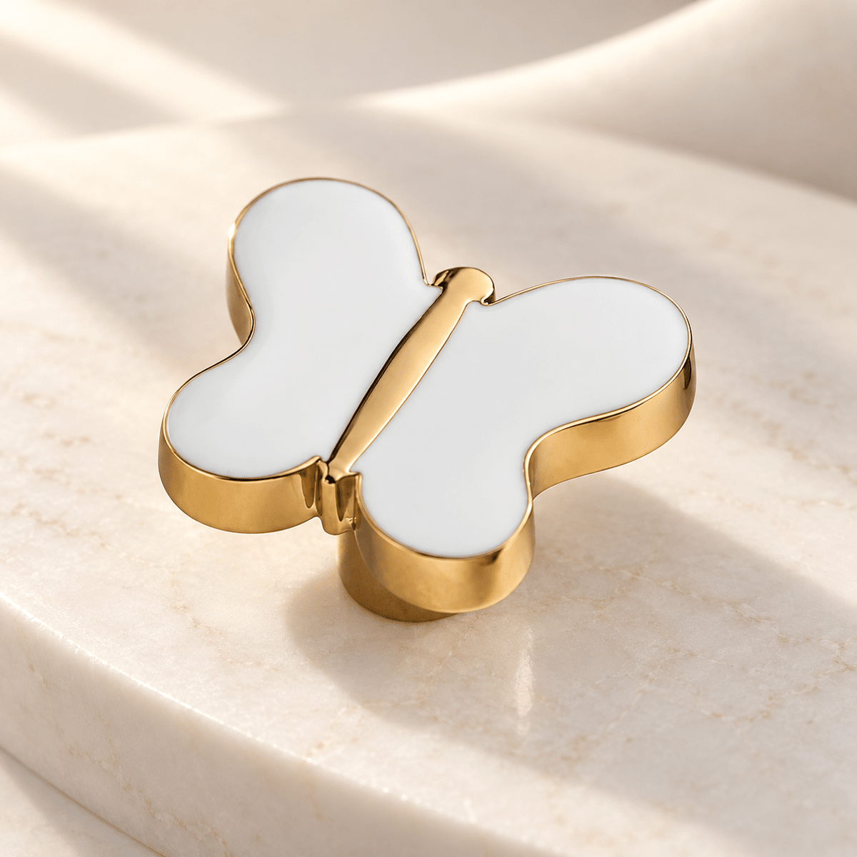 White butterfly cabinet knob in gold finish on ivory stone