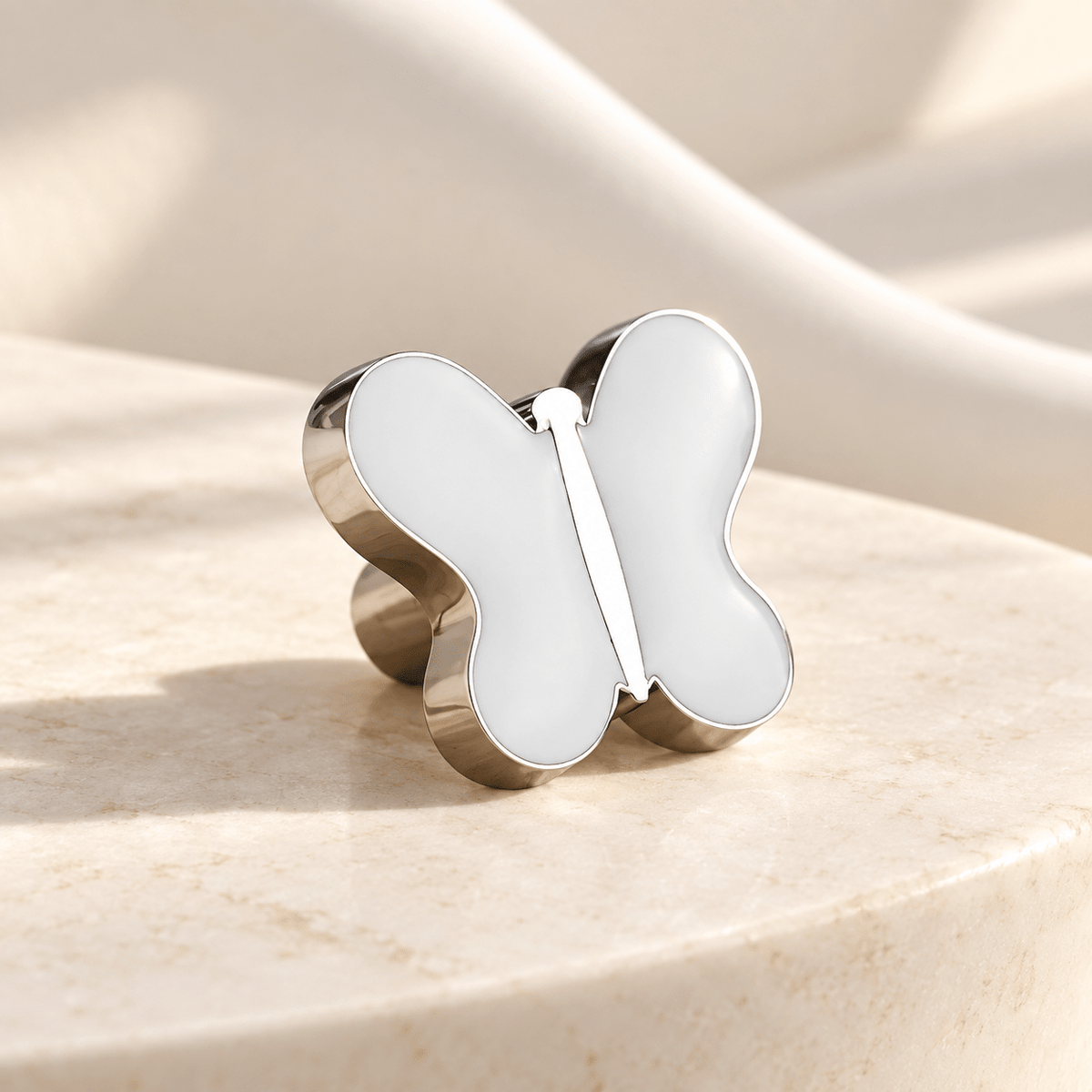 White butterfly cabinet knob in silver finish on ivory stone