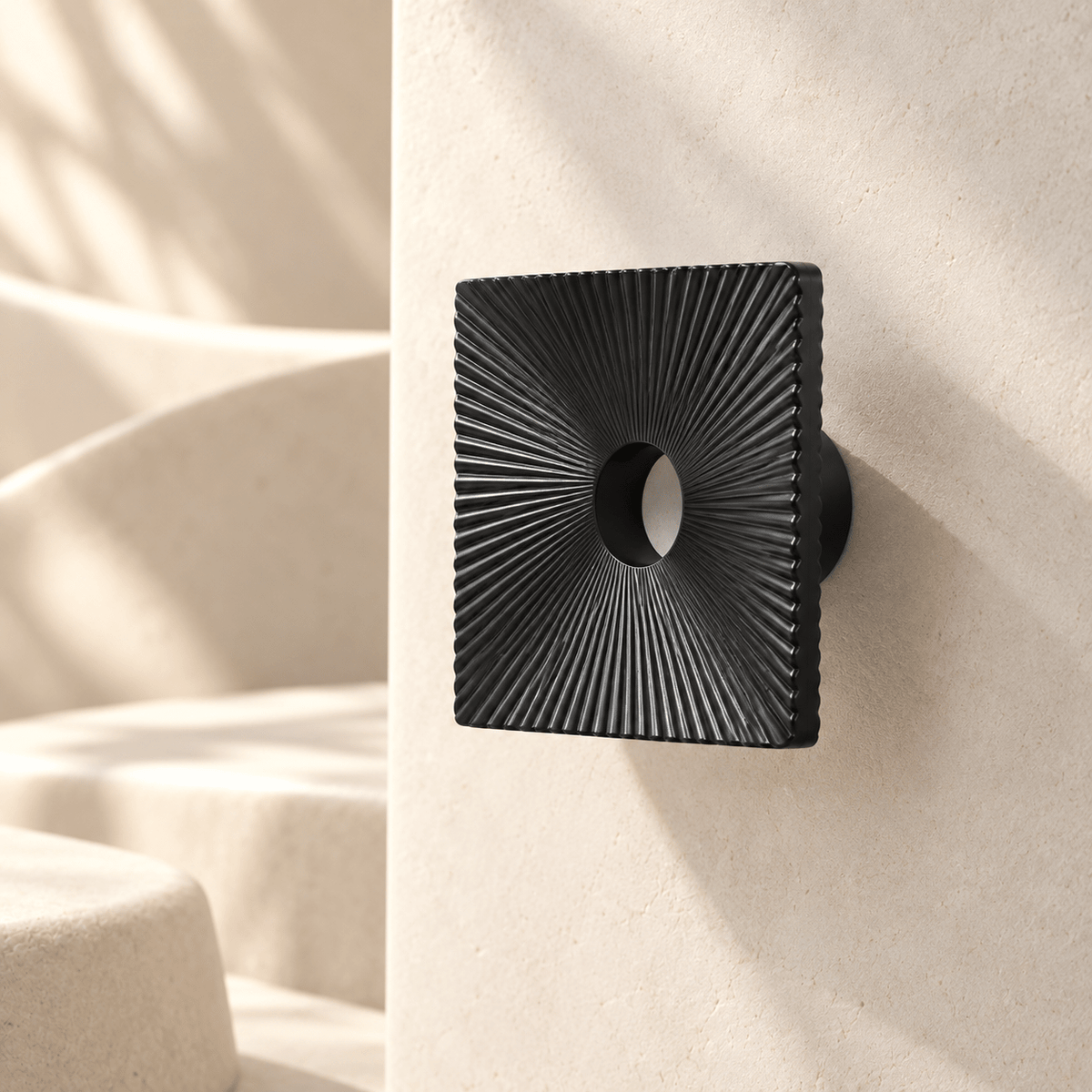Charcoal square sunburst cabinet pull, 85 mm face — warm ivory studio