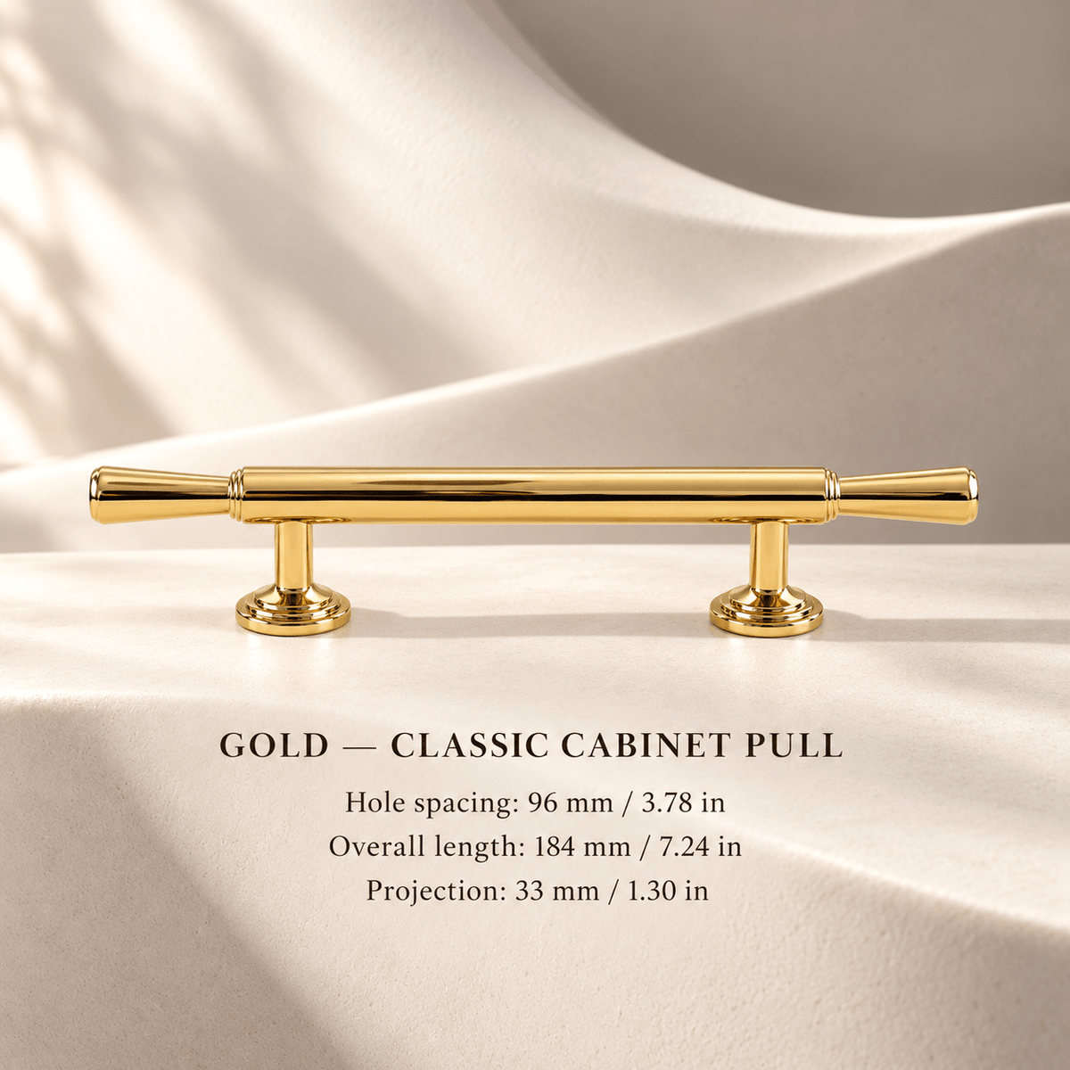 Polished gold classic cabinet pull in ivory studio. Hole spacing: 96 mm / 3.78 in; Overall length: 184 mm / 7.24 in; Projection: 33 mm / 1.30 in