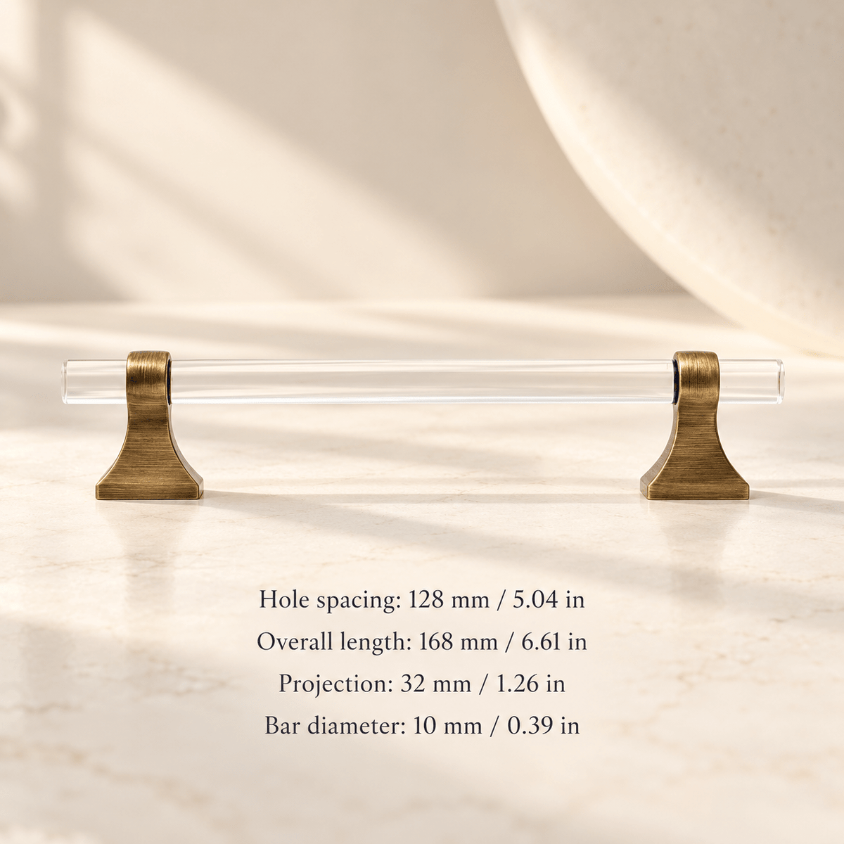 Clear acrylic cabinet hardware with antique bronze supports in ivory studio. Hole spacing: 128 mm / 5.04 in; Overall length: 168 mm / 6.61 in; Projection: 32 mm / 1.26 in; Bar diameter: 10 mm / 0.39 in