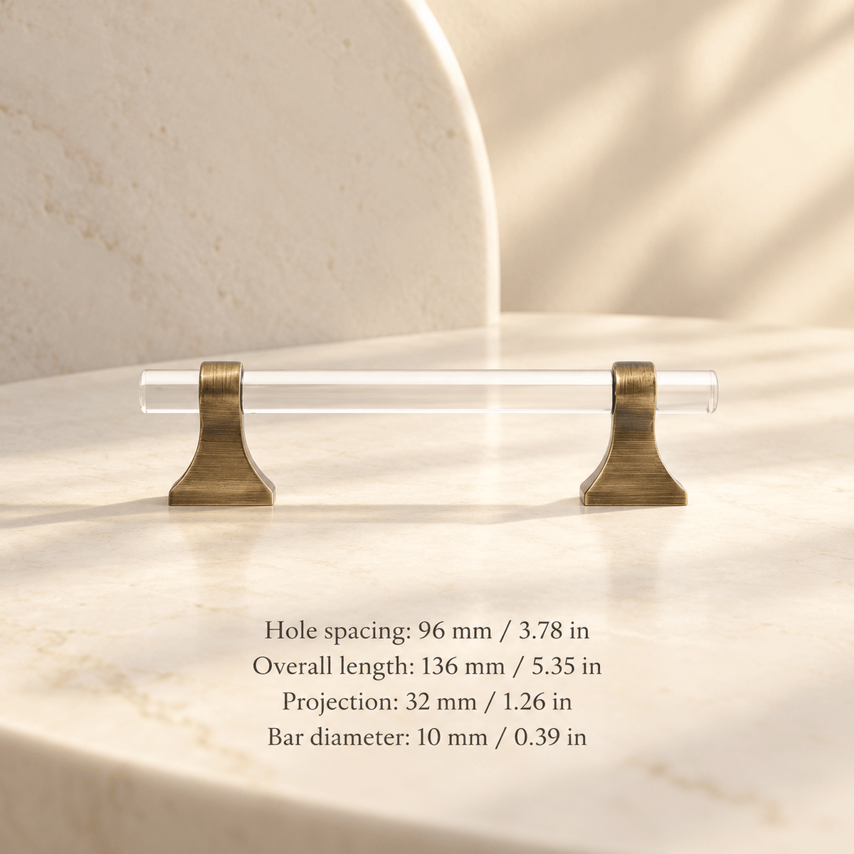 Clear acrylic cabinet hardware with antique bronze supports in ivory studio. Hole spacing: 96 mm / 3.78 in; Overall length: 136 mm / 5.35 in; Projection: 32 mm / 1.26 in; Bar diameter: 10 mm / 0.39 in