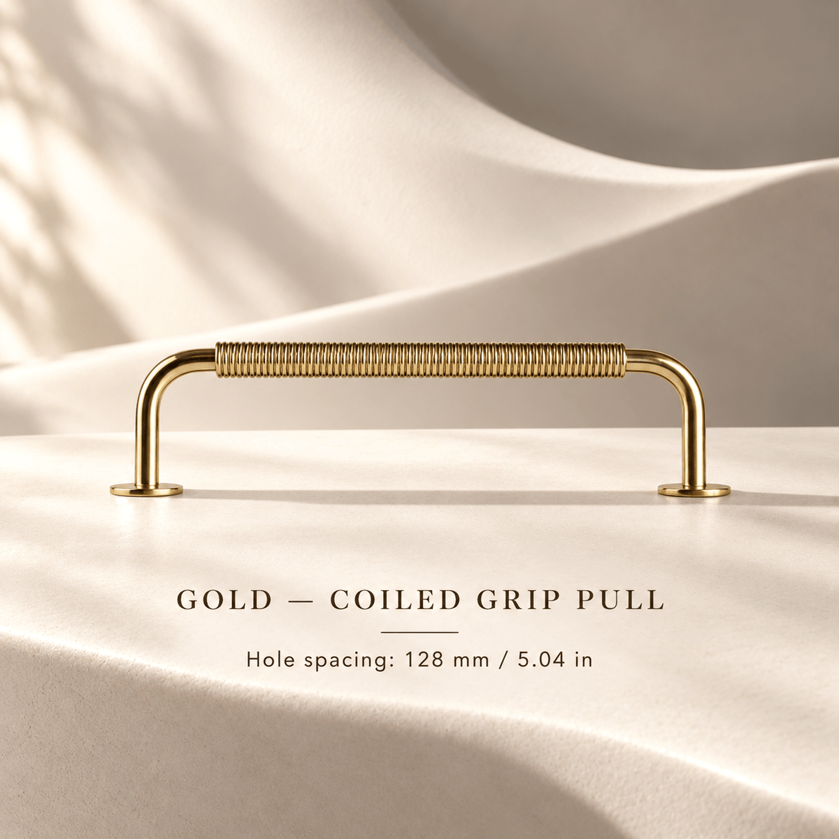 Gold coiled-grip cabinet pull in ivory studio. Hole spacing: 128 mm / 5.04 in