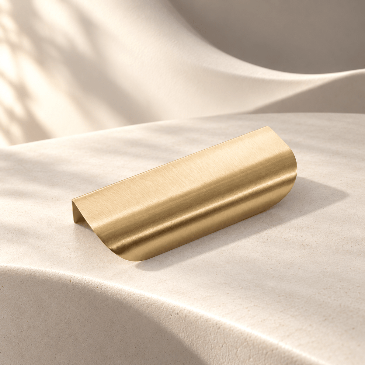 Large curved brass edge pull, warm ivory stone studio