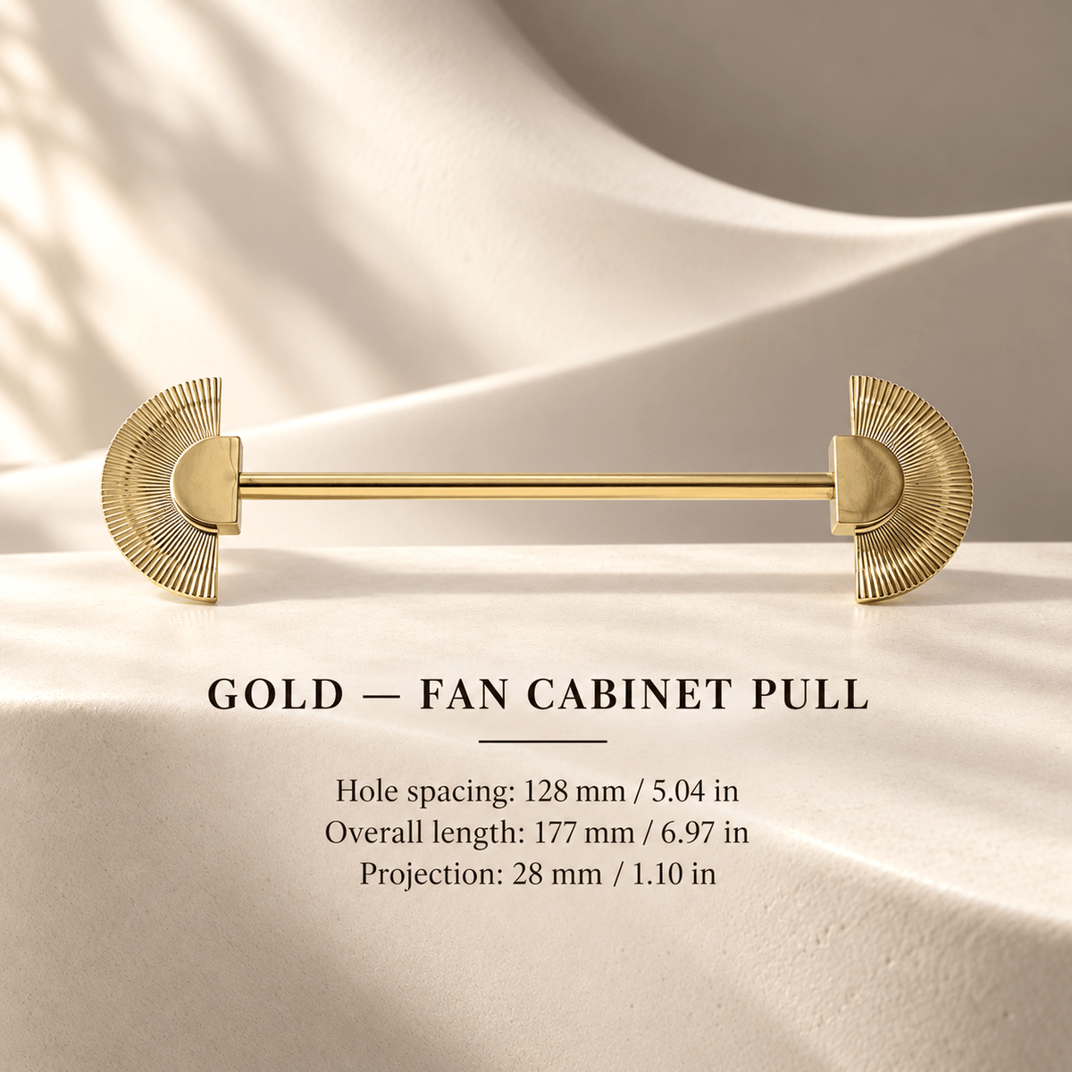 Gold fan cabinet pull in ivory studio. Hole spacing: 128 mm / 5.04 in; Overall length: 177 mm / 6.97 in; Projection: 28 mm / 1.10 in