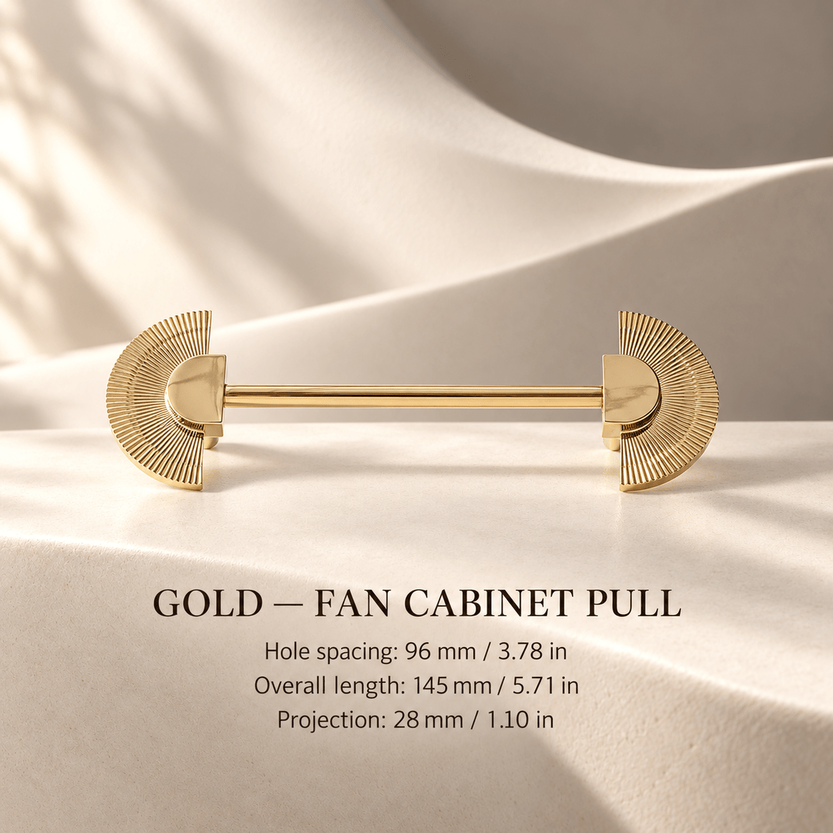 Gold fan cabinet pull in ivory studio. Hole spacing: 96 mm / 3.78 in; Overall length: 145 mm / 5.71 in; Projection: 28 mm / 1.10 in