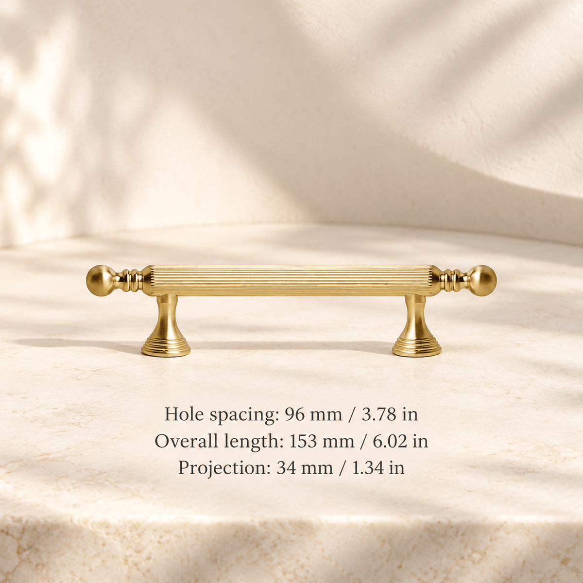 Gold fluted ball-finial cabinet hardware in ivory studio. Hole spacing: 96 mm / 3.78 in; Overall length: 153 mm / 6.02 in; Projection: 34 mm / 1.34 in