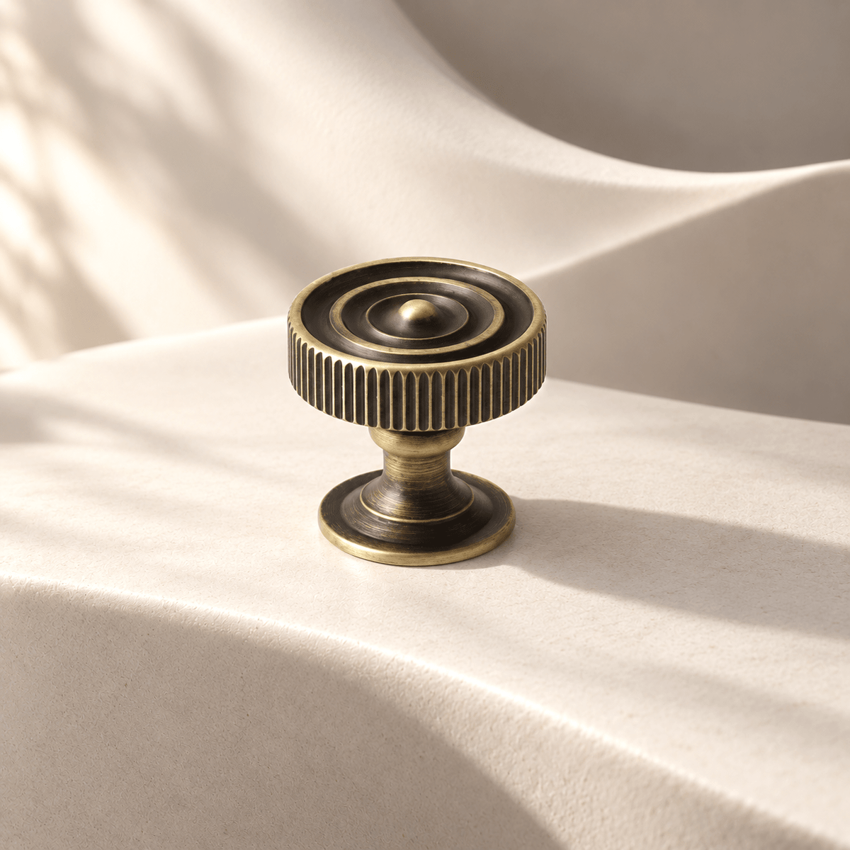 Bronze Knob fluted cabinet hardware on warm ivory stone