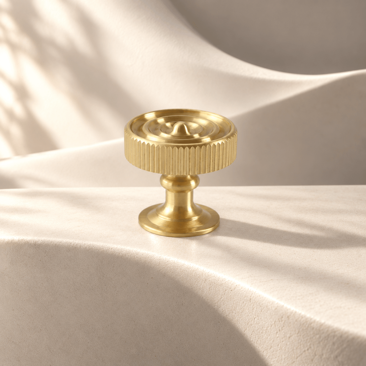 Gold Knob fluted cabinet hardware on warm ivory stone