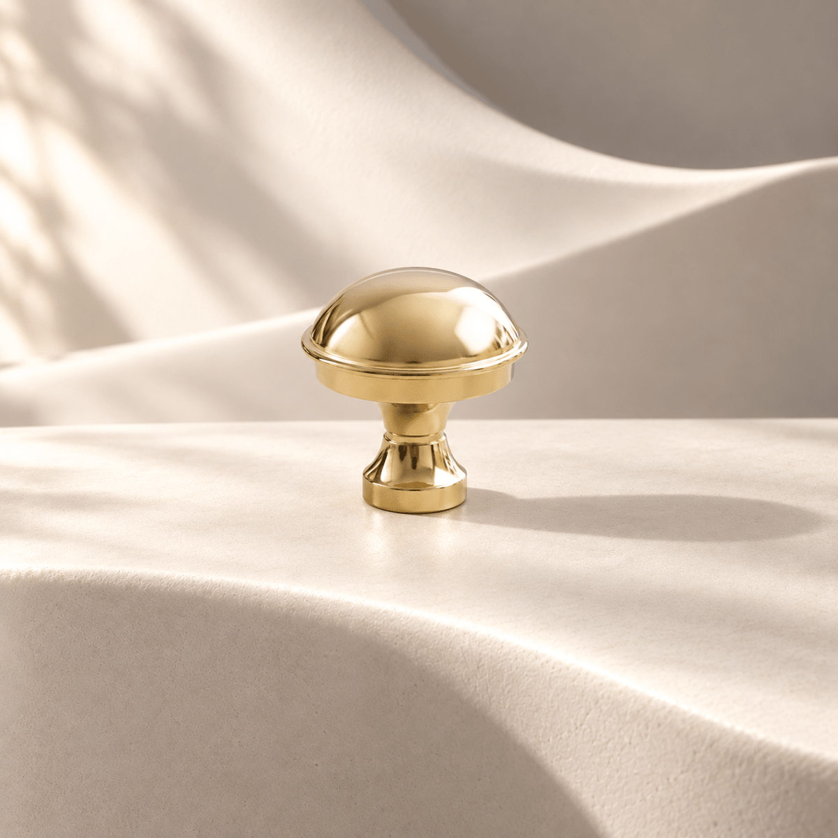 Polished gold dome knob — 29 mm diameter on warm ivory stone