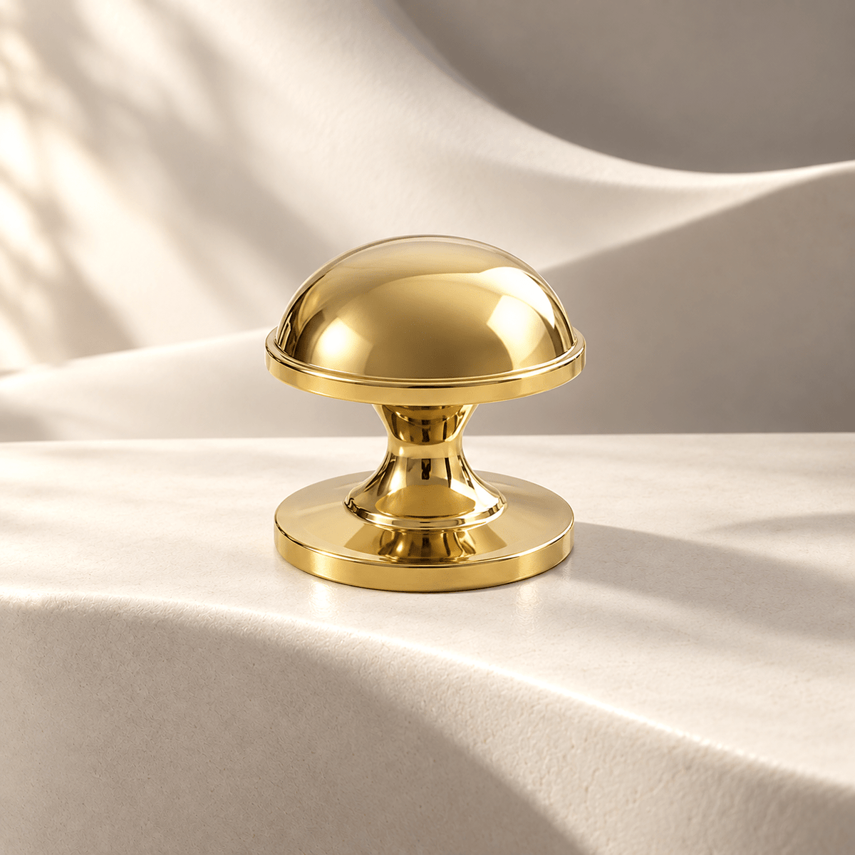 Polished gold dome knob — 32 mm diameter on warm ivory stone