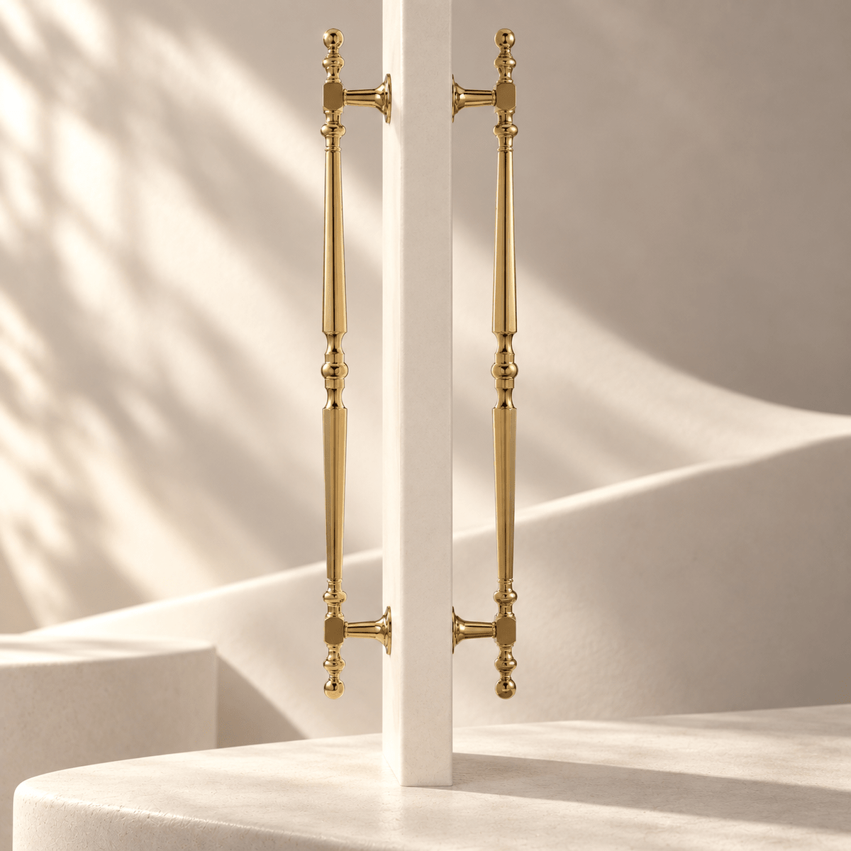 French-style gold finish door pull pair in an ivory stone studio