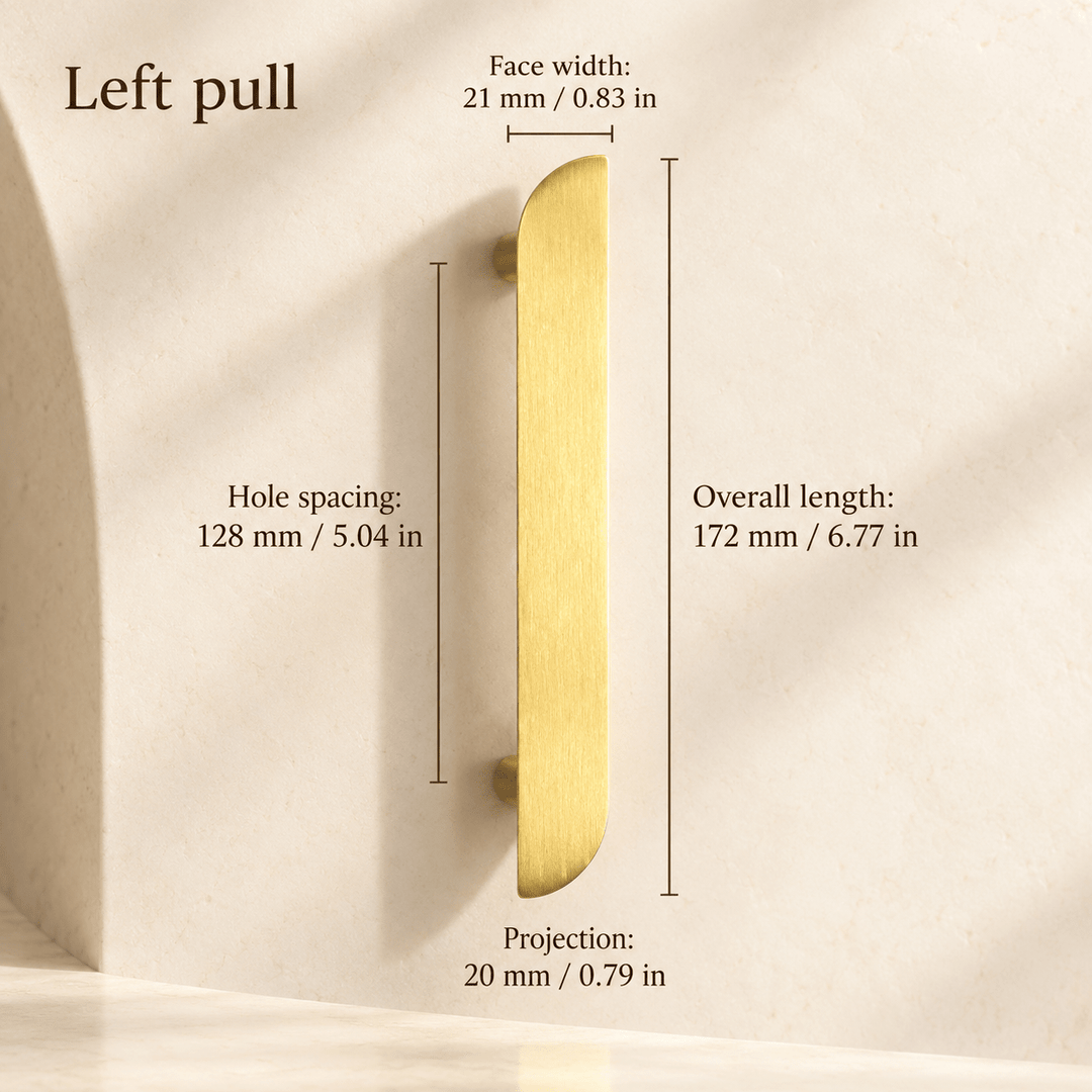 Gold asymmetric left cabinet pull in ivory studio. Hole spacing: 128 mm / 5.04 in; Overall length: 172 mm / 6.77 in; Face width: 21 mm / 0.83 in; Projection: 20 mm / 0.79 in