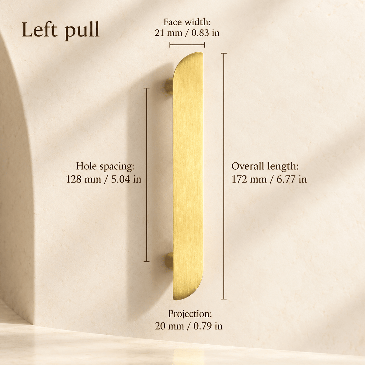 Gold asymmetric left cabinet pull in ivory studio. Hole spacing: 128 mm / 5.04 in; Overall length: 172 mm / 6.77 in; Face width: 21 mm / 0.83 in; Projection: 20 mm / 0.79 in