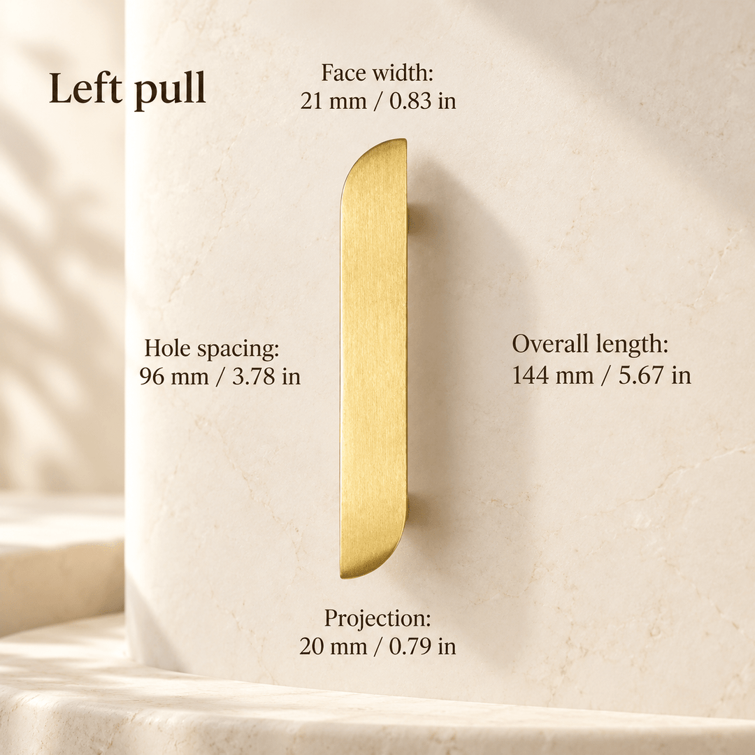 Gold asymmetric left cabinet pull in ivory studio. Hole spacing: 96 mm / 3.78 in; Overall length: 144 mm / 5.67 in; Face width: 21 mm / 0.83 in; Projection: 20 mm / 0.79 in