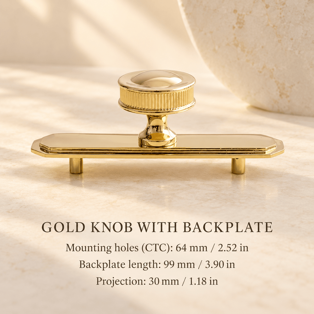 Glossy gold brass knob with backplate — mounting holes 64 mm / 2.52 in, length 99 mm / 3.90 in, projection 30 mm / 1.18 in — ivory stone studio