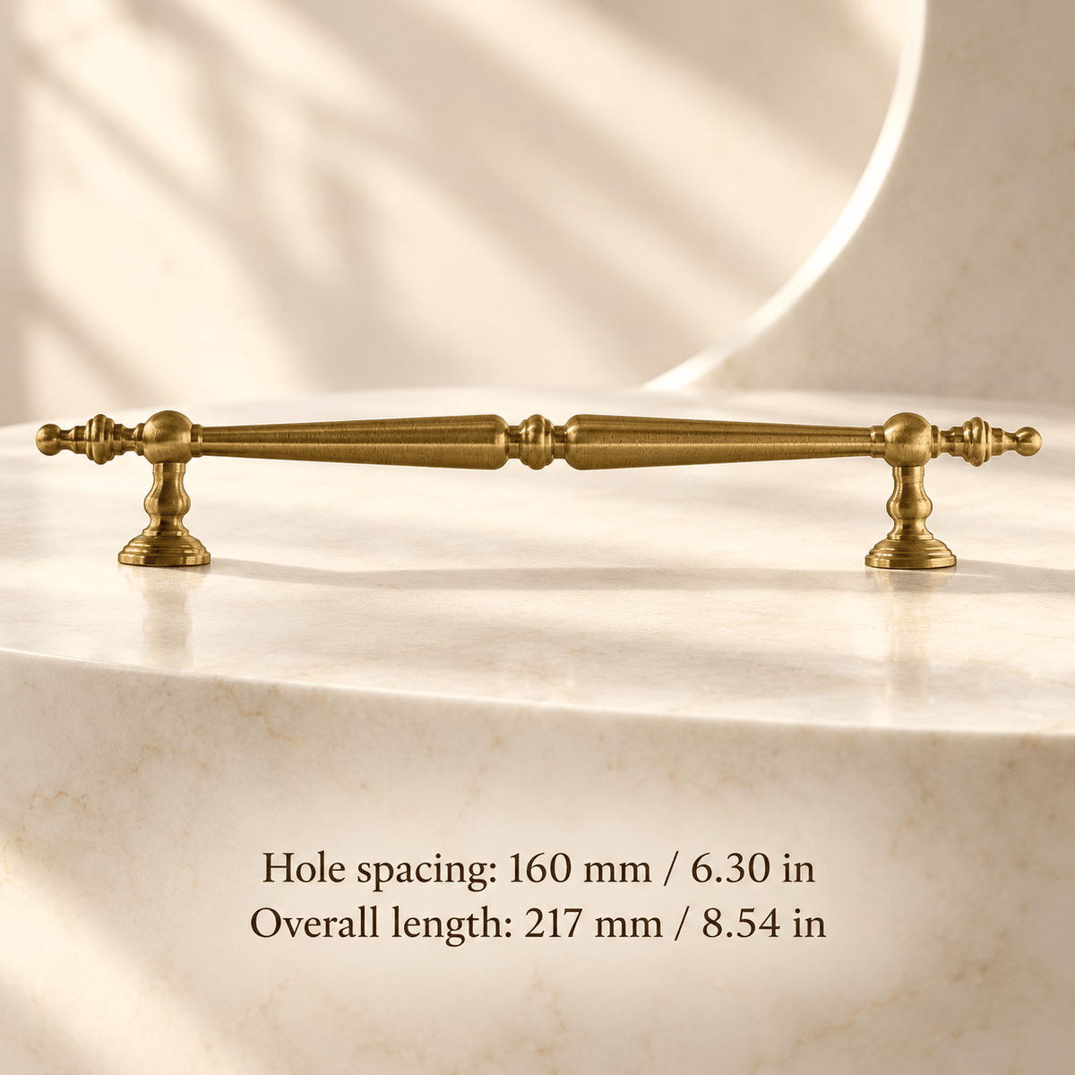 Classic gold finial cabinet pull in ivory studio. Hole spacing: 160 mm / 6.30 in; Overall length: 217 mm / 8.54 in