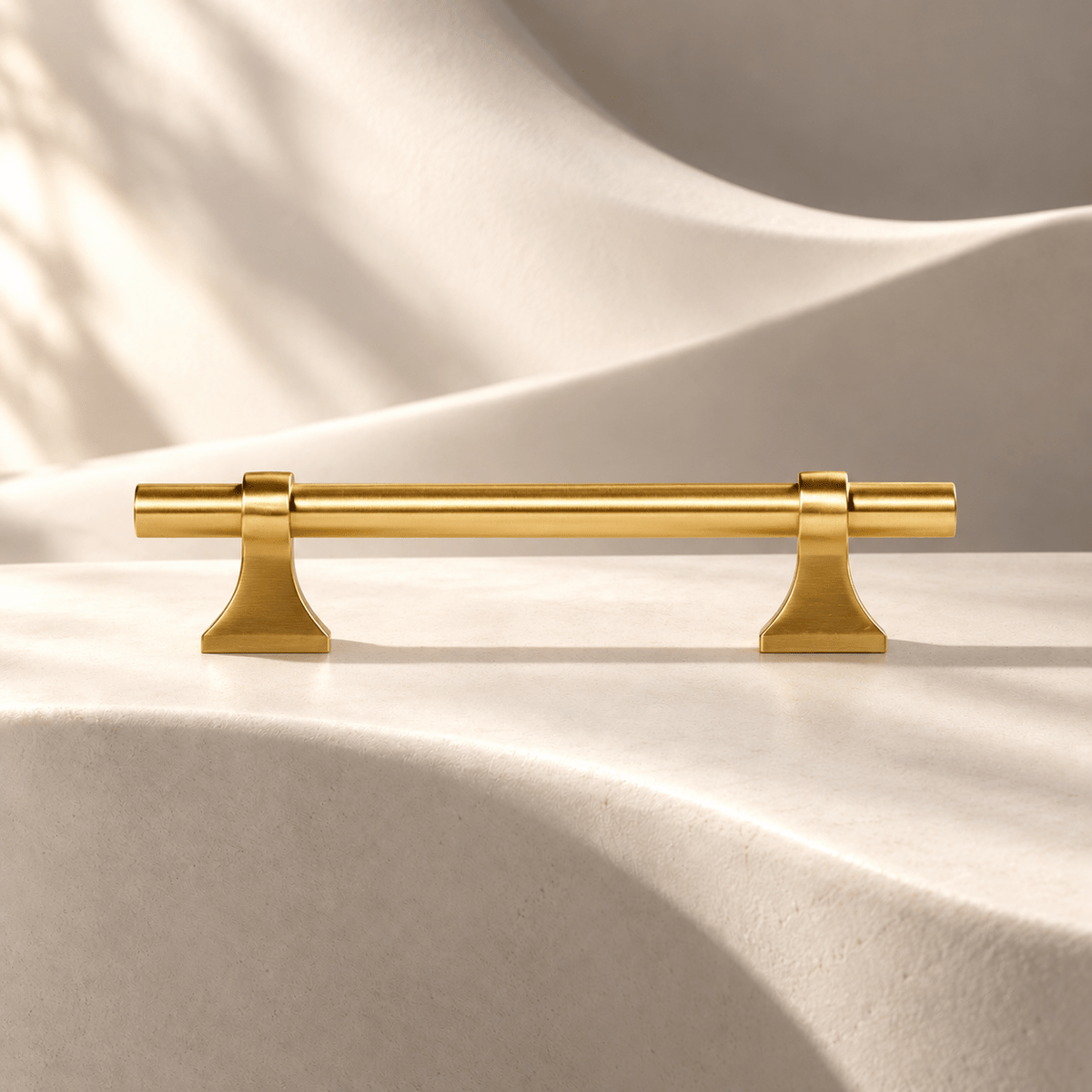 Gold flared-foot 96 mm CTC cabinet pull — warm ivory studio