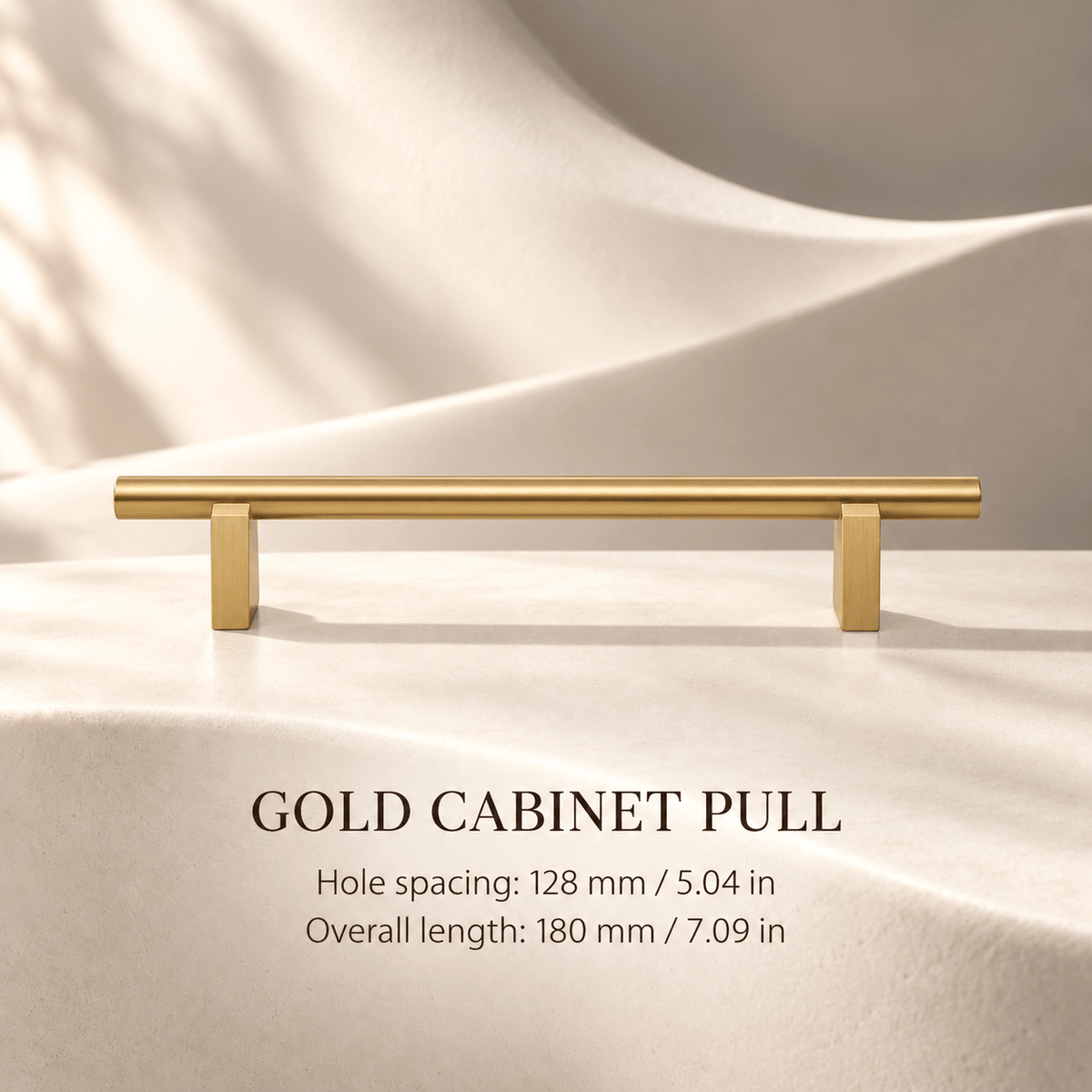 Gold cabinet pull with flat supports in ivory studio. Hole spacing: 128 mm / 5.04 in; Overall length: 180 mm / 7.09 in.