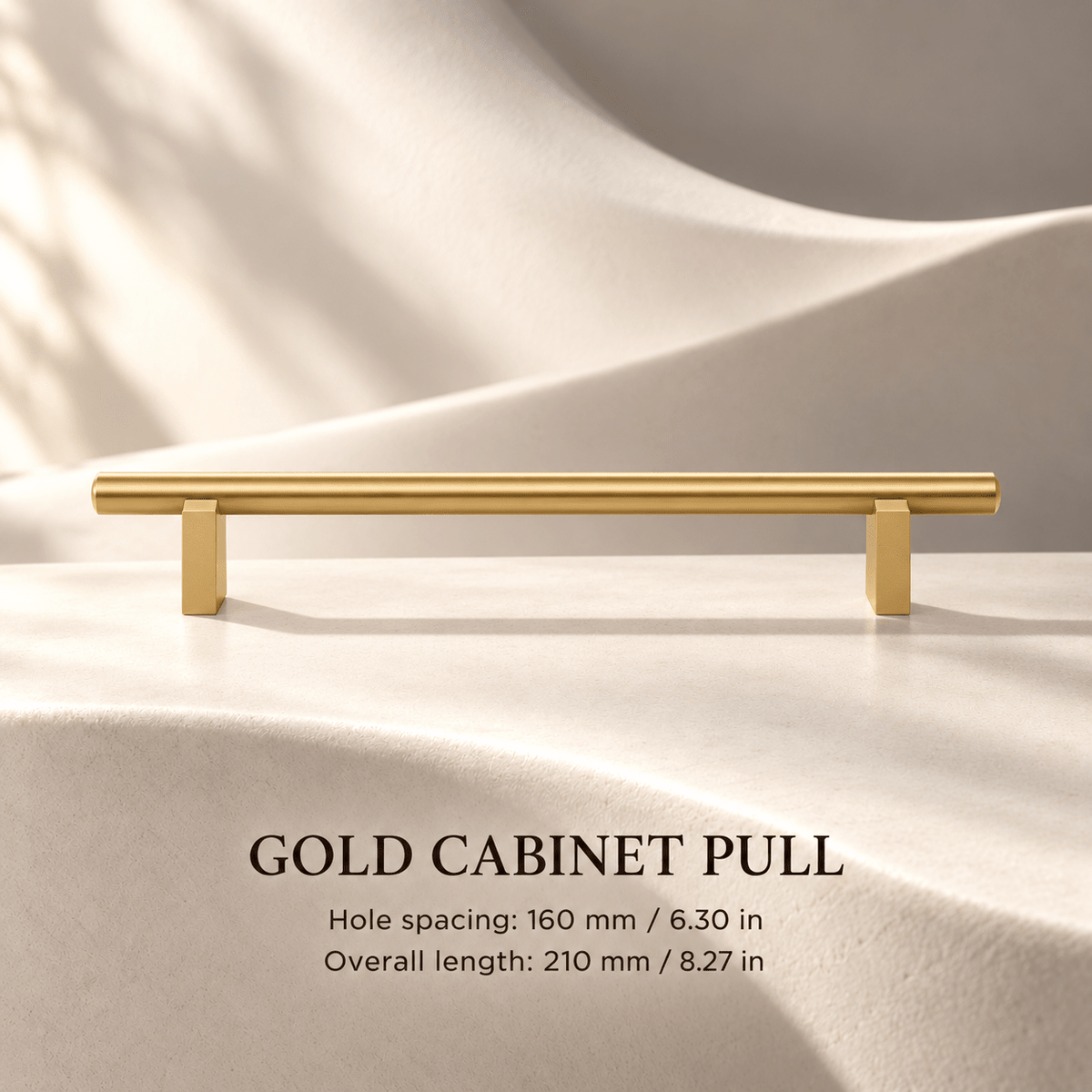 Gold cabinet pull with flat supports in ivory studio. Hole spacing: 160 mm / 6.30 in; Overall length: 210 mm / 8.27 in.