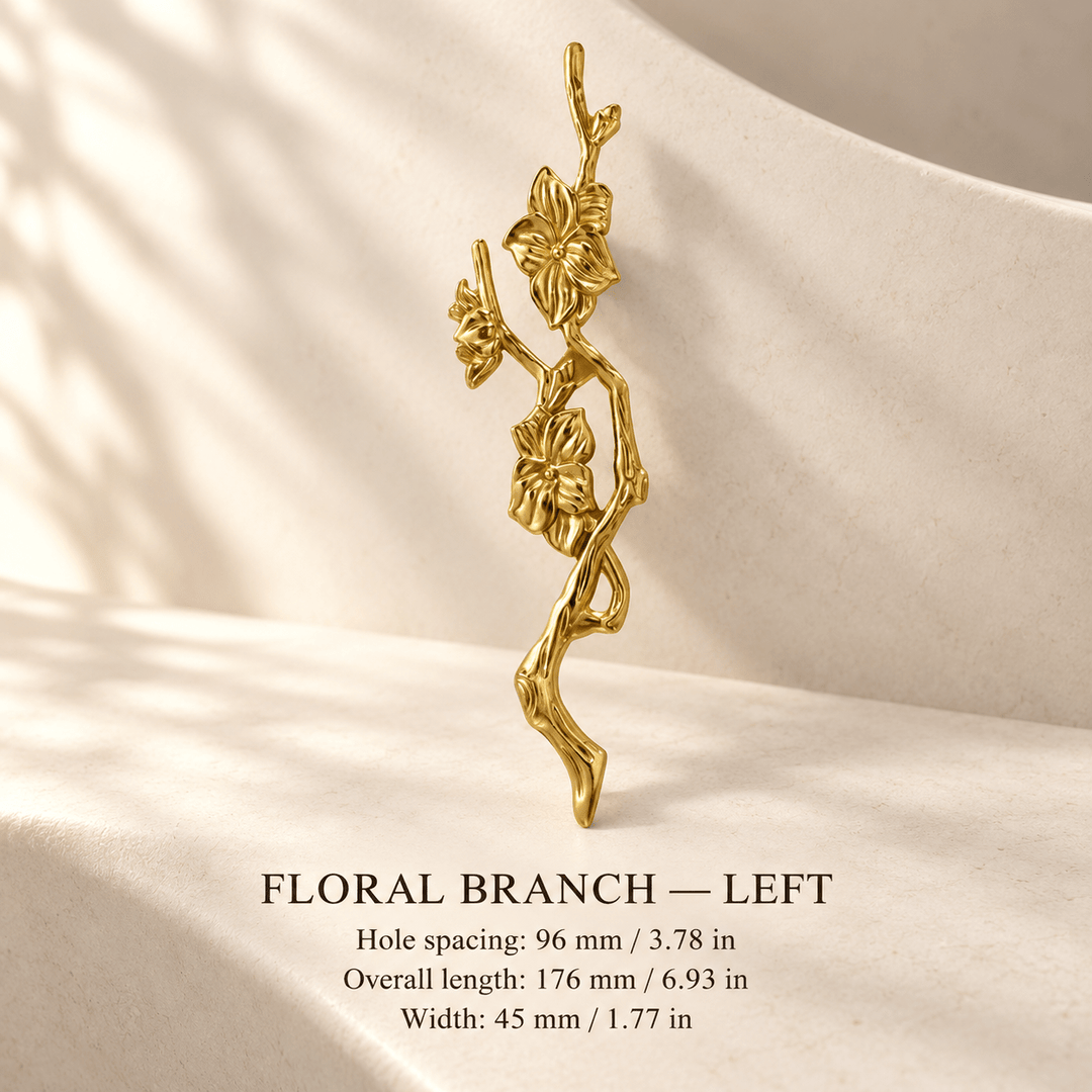 Gold floral branch cabinet pull, left, in ivory studio. Hole spacing: 96 mm / 3.78 in; Overall length: 176 mm / 6.93 in; Width: 45 mm / 1.77 in