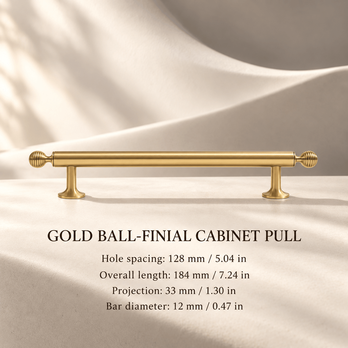 Gold ball-finial cabinet pull, 128 mm hole spacing, individual millimeter and inch measurements in an ivory studio