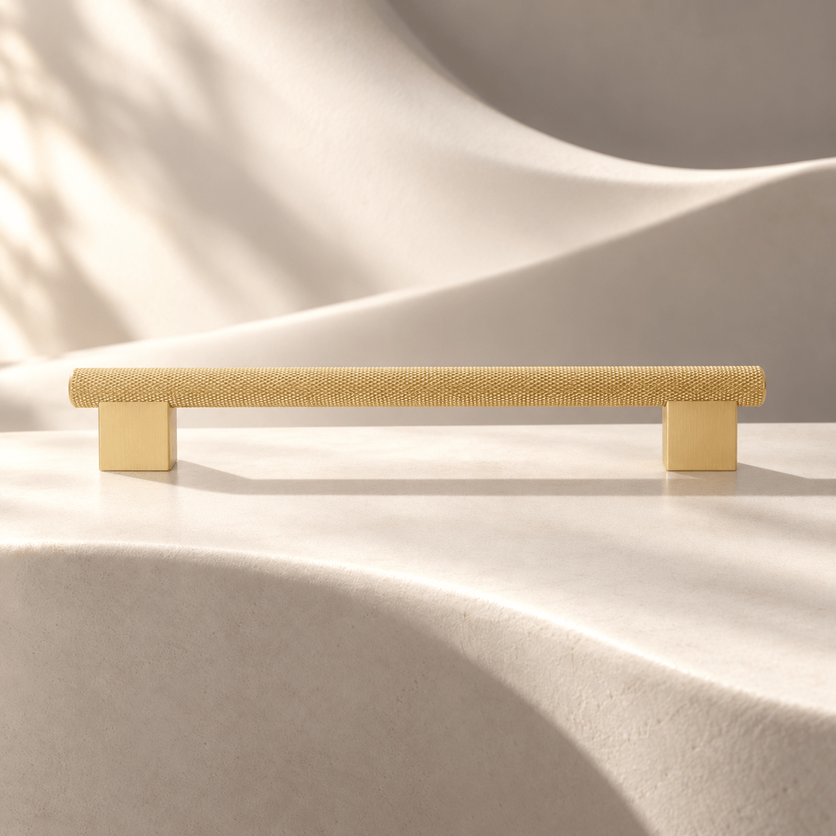 Satin gold knurled cabinet pull, 192 mm hole spacing on ivory stone