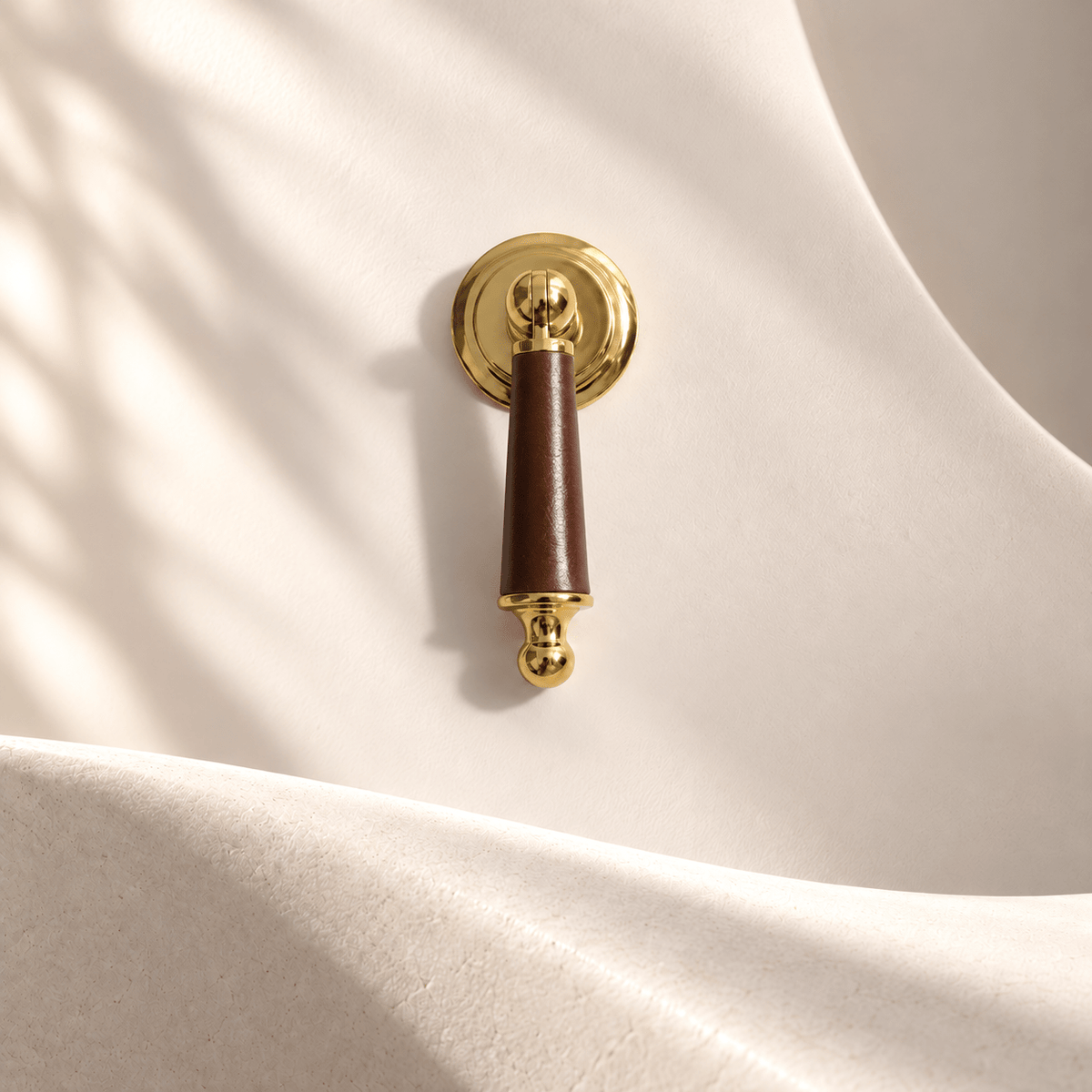 Gold-finish brown leather cabinet drop pull in warm ivory studio