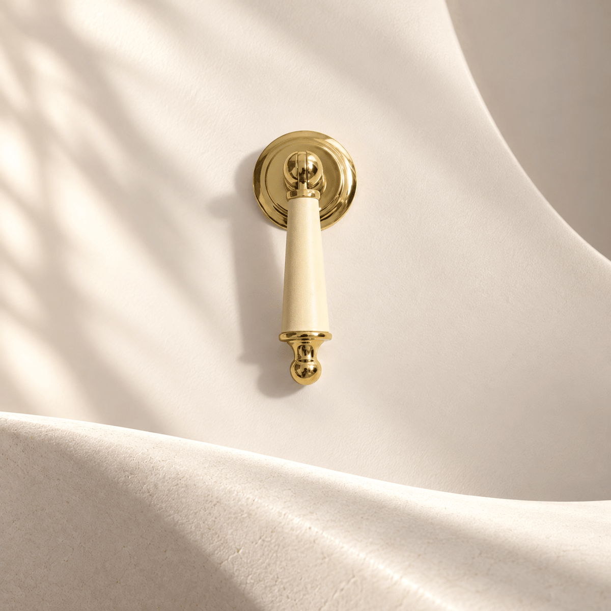 Gold-finish light yellow leather cabinet drop pull in warm ivory studio