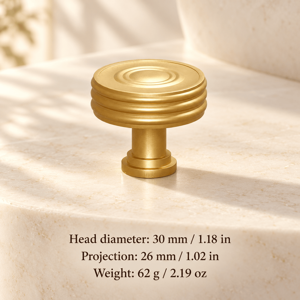 Gold ribbed cabinet knob in ivory studio. Head diameter: 30 mm / 1.18 in; Projection: 26 mm / 1.02 in; Weight: 62 g / 2.19 oz