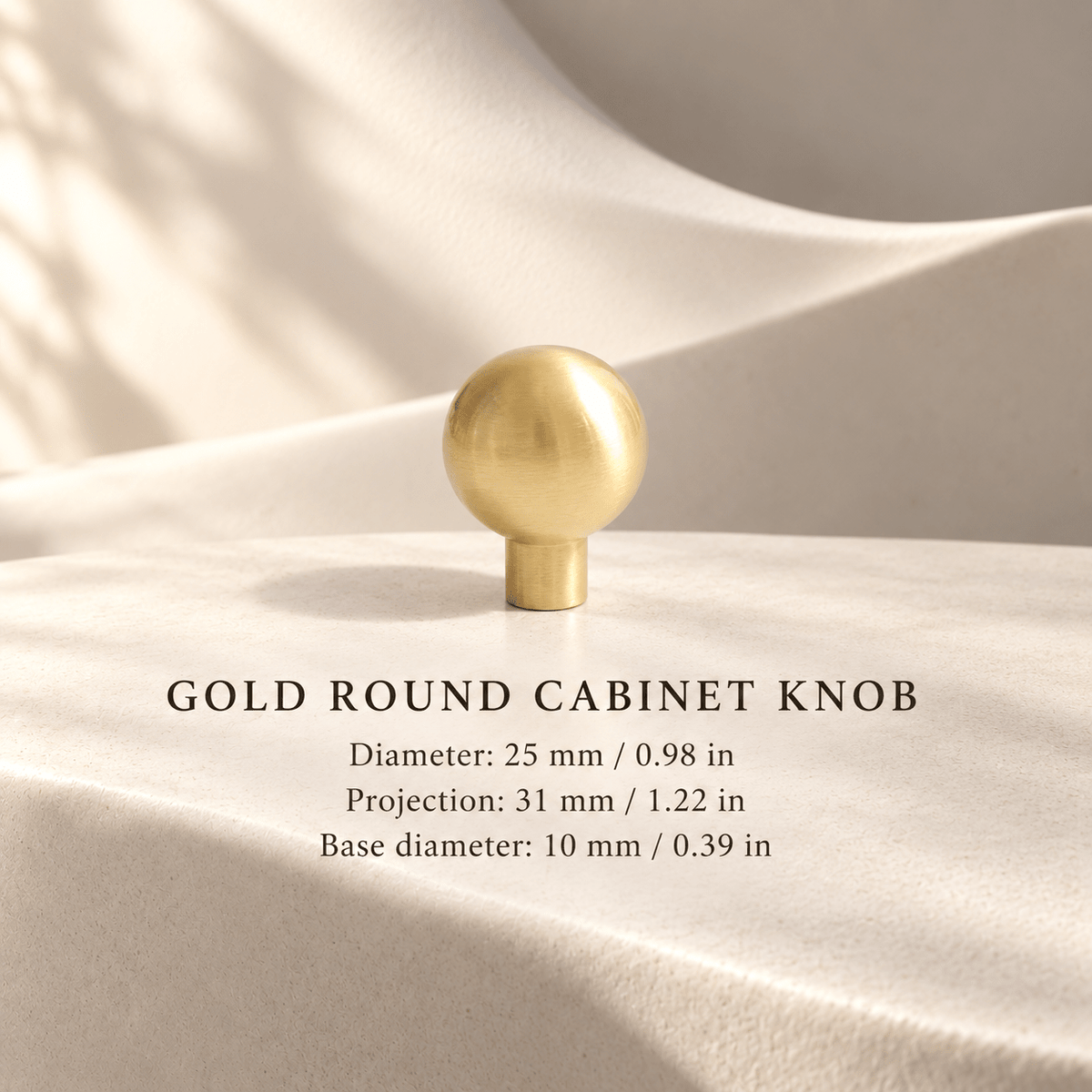 Gold round cabinet knob Stem25, 25 mm diameter and 31 mm projection, individual mm and inch measurements in an ivory studio