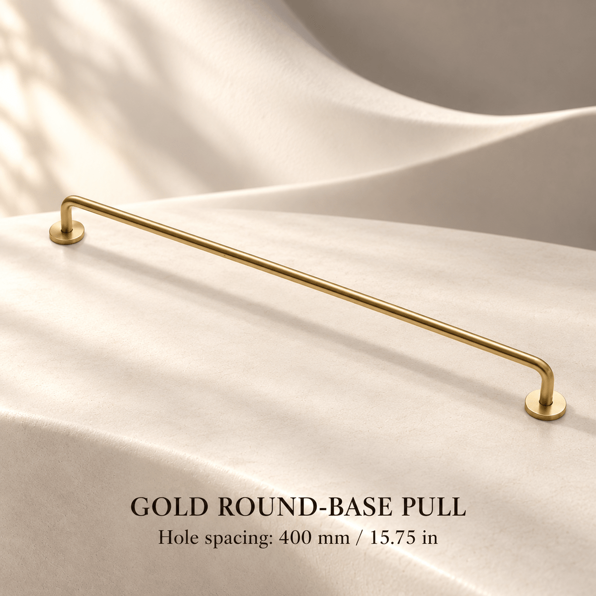 Gold slim cabinet pull with round mounting bases, 400 mm (15.75 in) hole spacing, ivory studio.