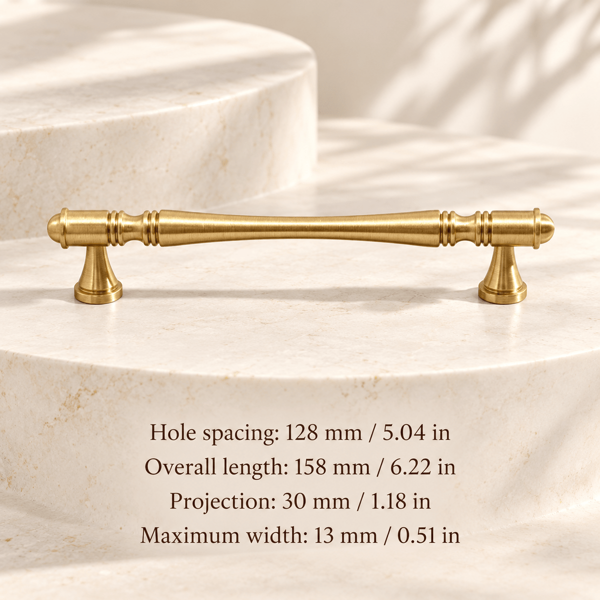 Gold waisted spindle cabinet pull in ivory studio. Hole spacing: 128 mm / 5.04 in; Overall length: 158 mm / 6.22 in; Projection: 30 mm / 1.18 in; Maximum width: 13 mm / 0.51 in