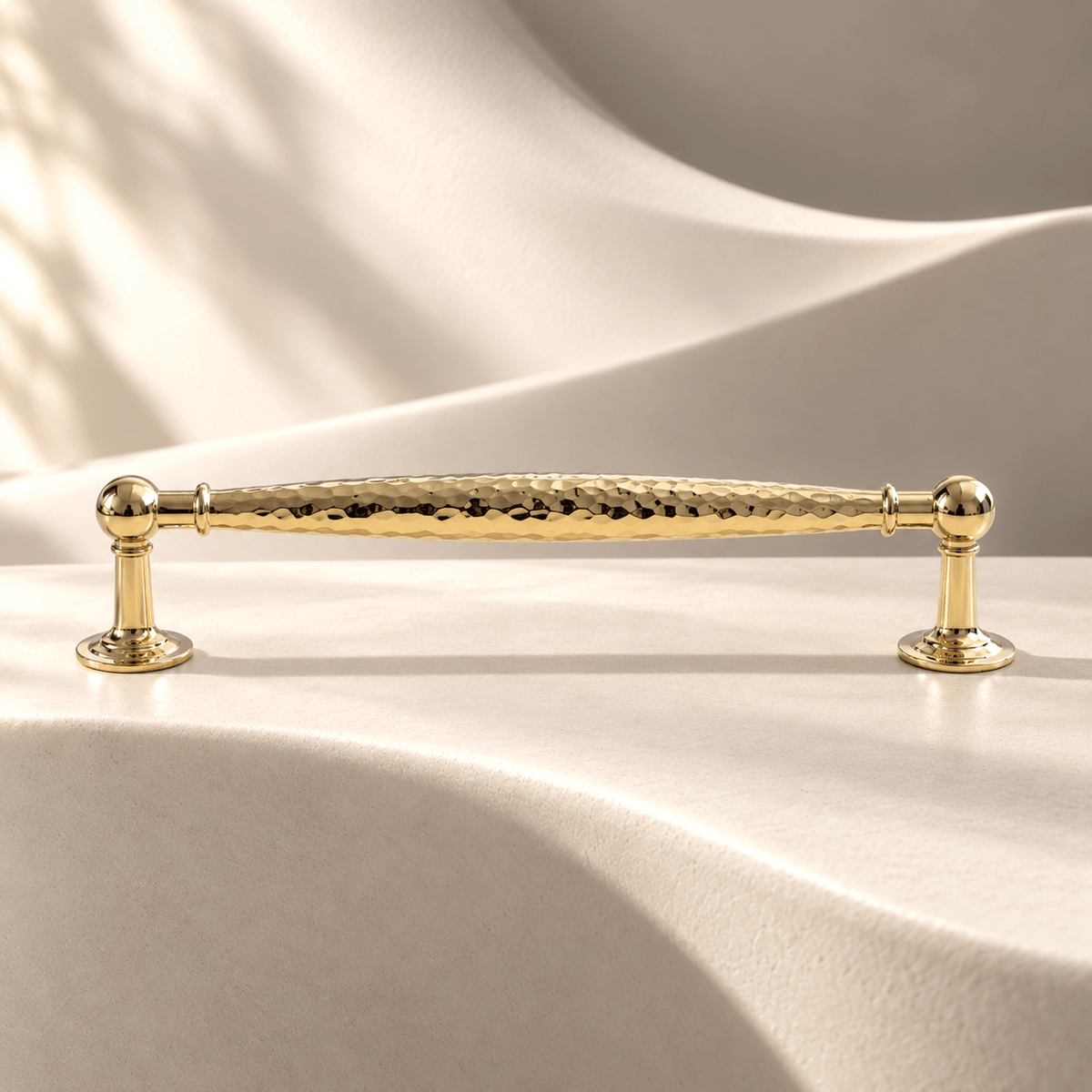 Polished gold hammered cabinet pull — 160 mm CTC on warm ivory stone