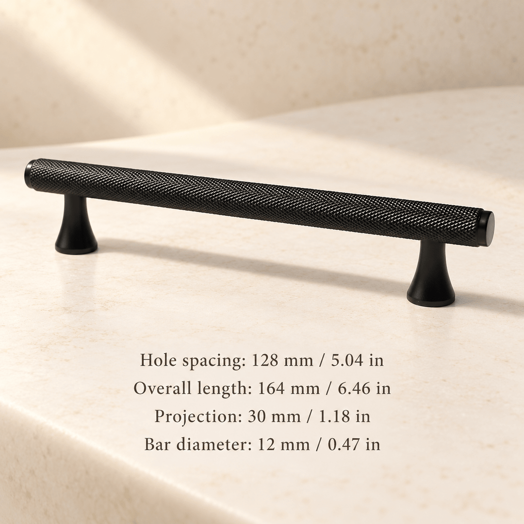 Black knurled cabinet pull with flared feet in ivory studio. Hole spacing: 128 mm / 5.04 in; Overall length: 164 mm / 6.46 in; Projection: 30 mm / 1.18 in; Bar diameter: 12 mm / 0.47 in