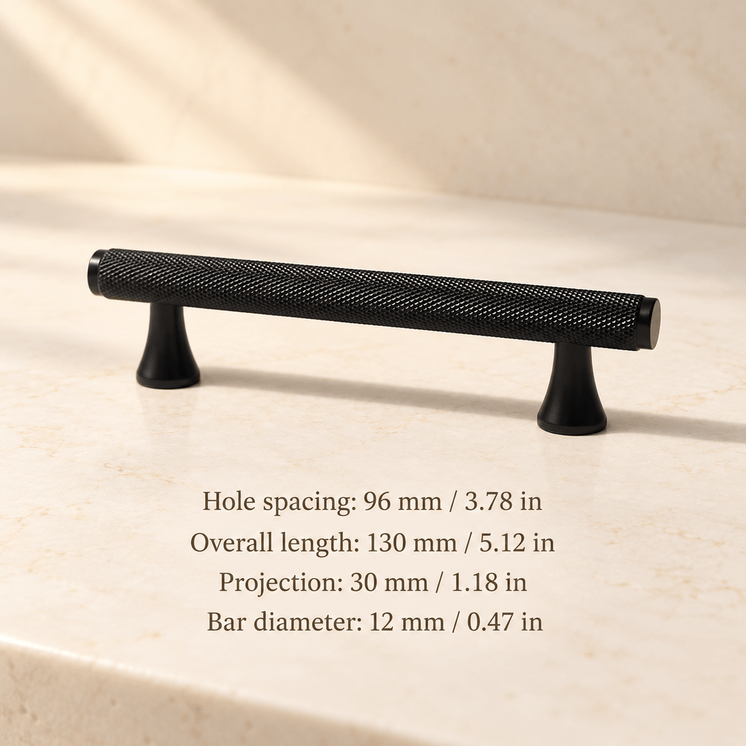 Black knurled cabinet pull with flared feet in ivory studio. Hole spacing: 96 mm / 3.78 in; Overall length: 130 mm / 5.12 in; Projection: 30 mm / 1.18 in; Bar diameter: 12 mm / 0.47 in