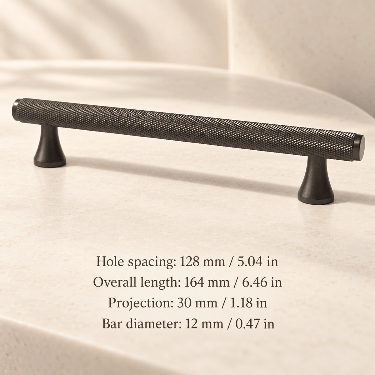 Grey knurled cabinet pull with flared feet in ivory studio. Hole spacing: 128 mm / 5.04 in; Overall length: 164 mm / 6.46 in; Projection: 30 mm / 1.18 in; Bar diameter: 12 mm / 0.47 in