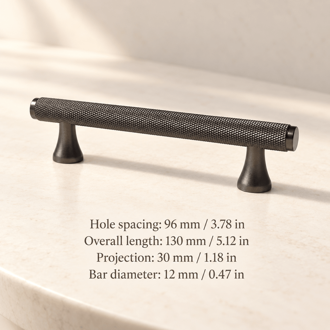 Grey knurled cabinet pull with flared feet in ivory studio. Hole spacing: 96 mm / 3.78 in; Overall length: 130 mm / 5.12 in; Projection: 30 mm / 1.18 in; Bar diameter: 12 mm / 0.47 in