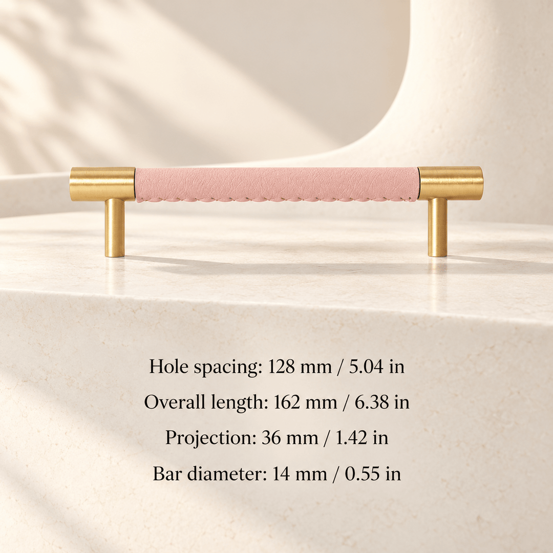 pink leather cabinet pull with gold ends in ivory studio. Hole spacing: 128 mm / 5.04 in; Overall length: 162 mm / 6.38 in; Projection: 36 mm / 1.42 in; Bar diameter: 14 mm / 0.55 in