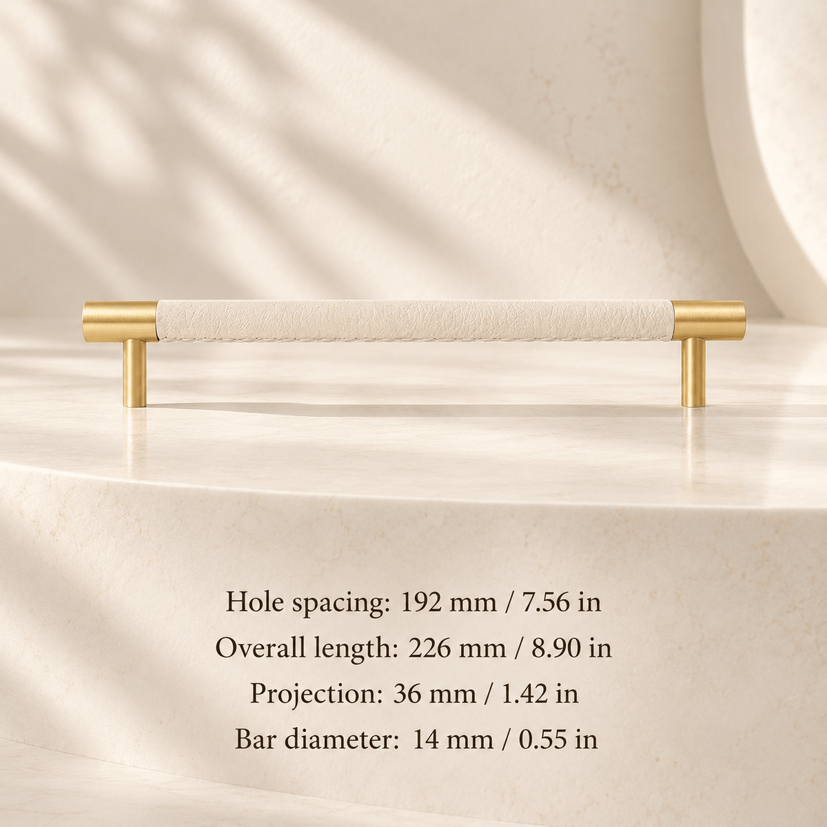 ivory white leather cabinet pull with gold ends in ivory studio. Hole spacing: 192 mm / 7.56 in; Overall length: 226 mm / 8.90 in; Projection: 36 mm / 1.42 in; Bar diameter: 14 mm / 0.55 in