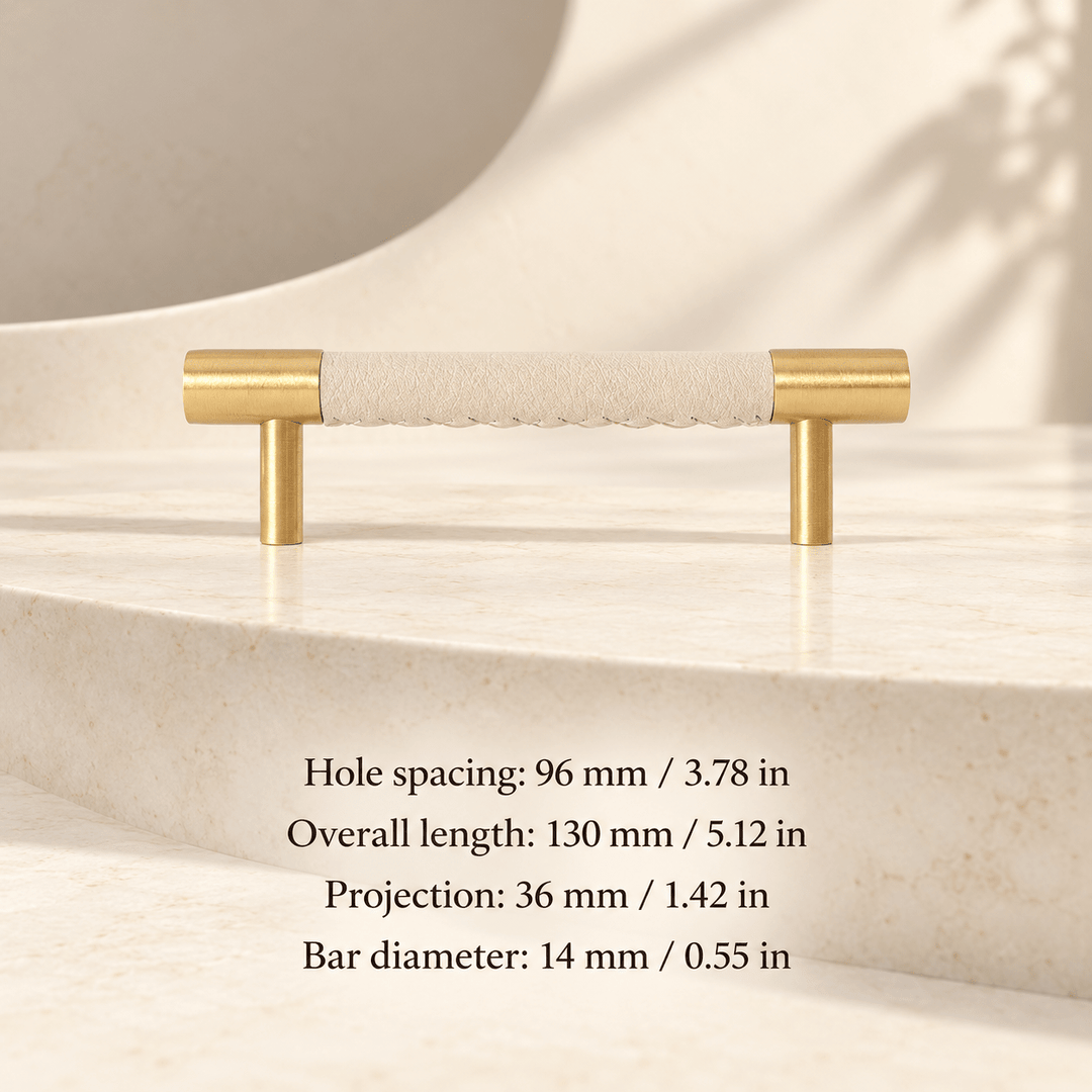 ivory white leather cabinet pull with gold ends in ivory studio. Hole spacing: 96 mm / 3.78 in; Overall length: 130 mm / 5.12 in; Projection: 36 mm / 1.42 in; Bar diameter: 14 mm / 0.55 in