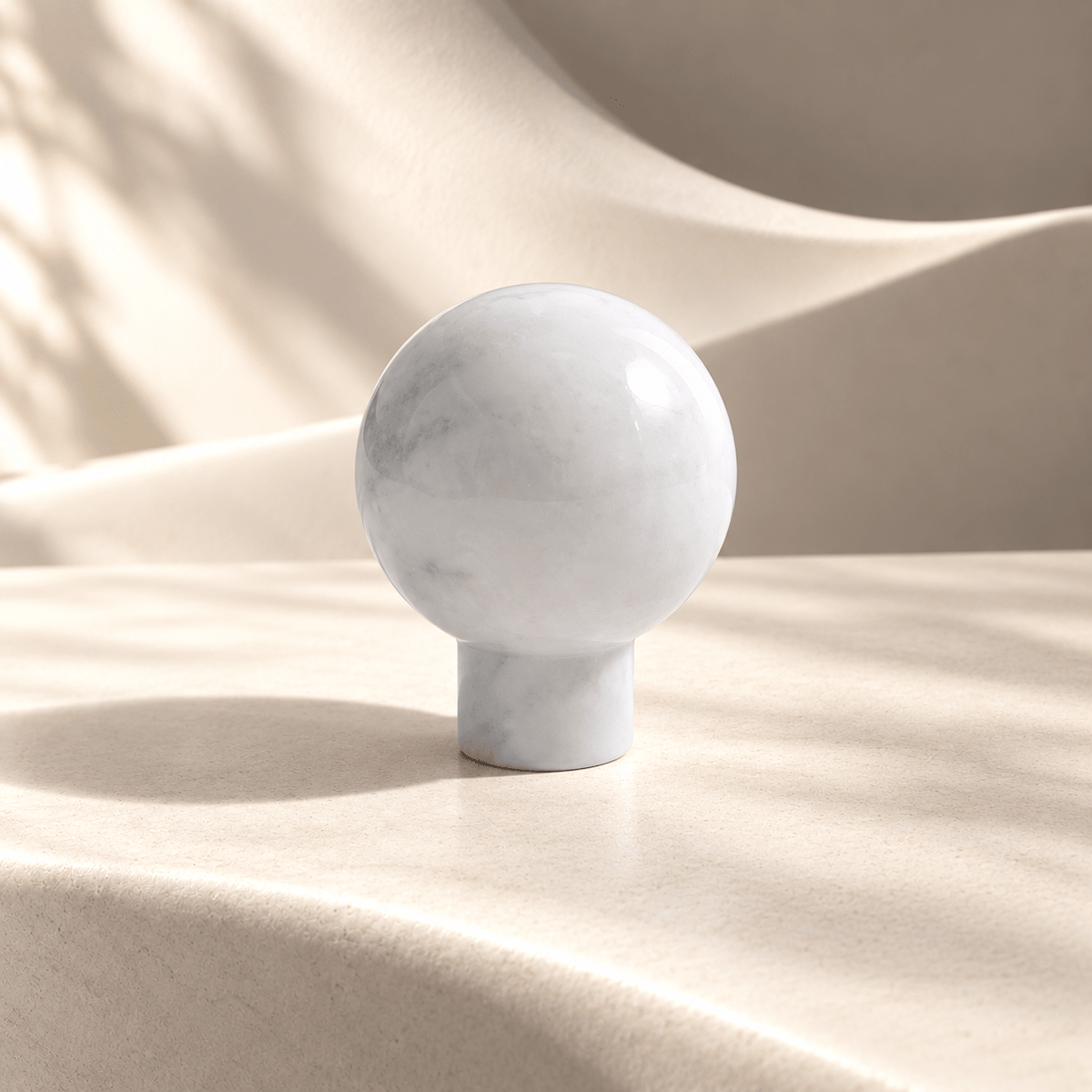 White 30 mm marble-style sphere knob on ivory stone